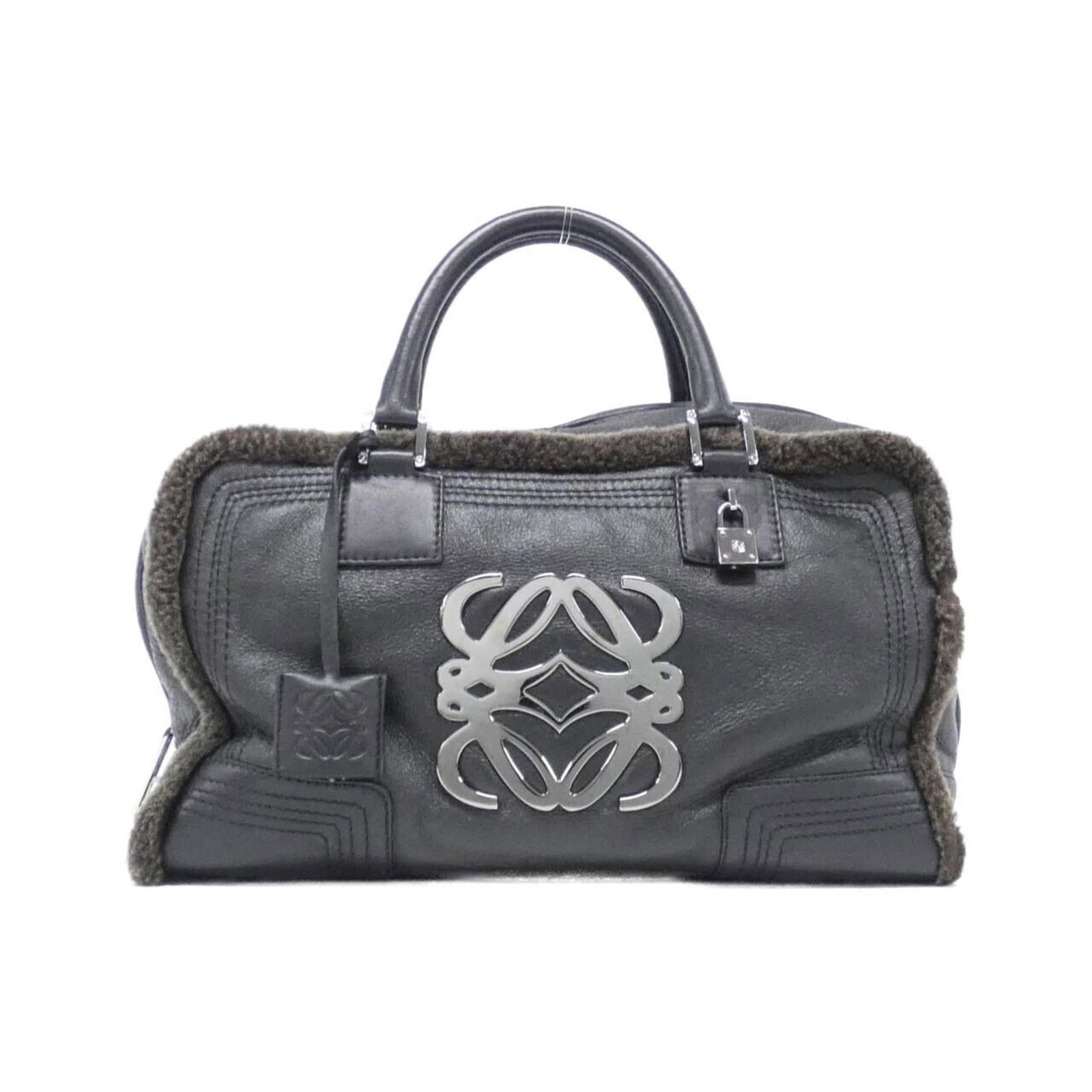 Leather Loewe Handbag: Leather Loewe Handbag This listing features Leather Loewe Handbag. Item specifics are provided below. Item Specifics: Brand: Loewe Type: Handbag Material: Leather Leather/Fur Type: Mouton Color: