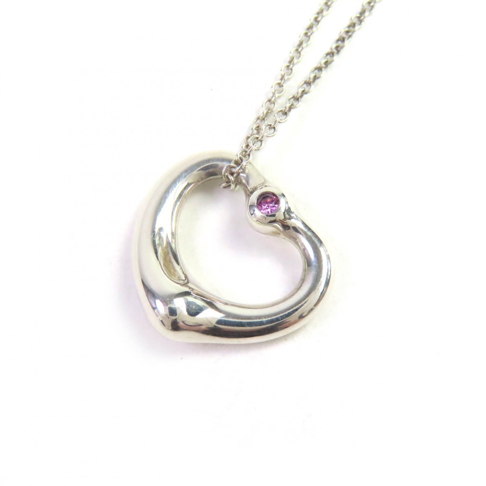 for Women - TIFFANY & Co. Tiffany Elsa Peretti Open Heart Pendant Necklace in 925 Sterling Silver: for Women - TIFFANY & Co. Tiffany Elsa Peretti Open Heart Pendant Necklace in 925 Sterling Silver with a Pink Sapphire - Made Spain - Weight 3.6g This listing features for Women - TIFFANY & Co.