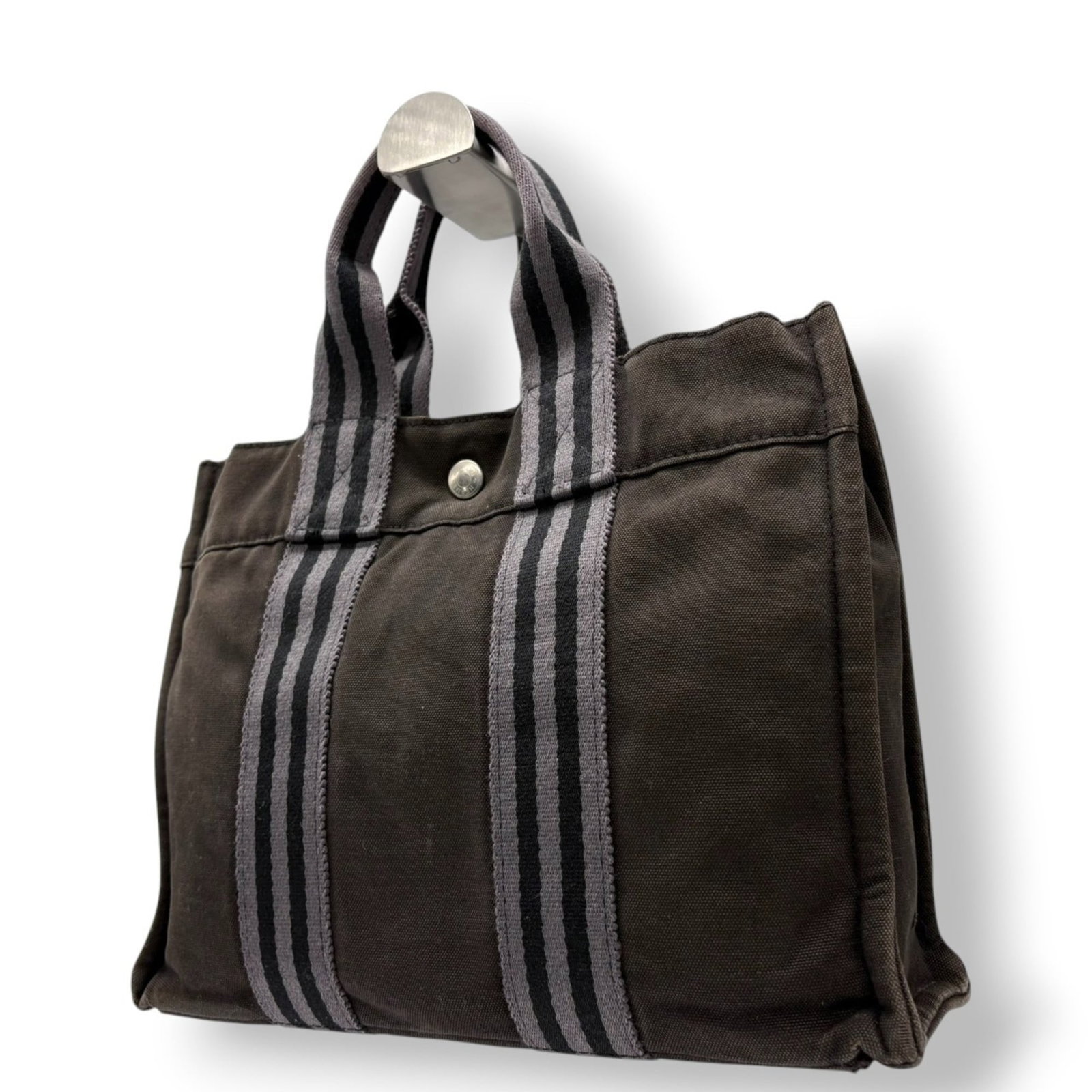 Canvas Hermes Tote Bag: Canvas Hermes Tote Bag This listing features Canvas Hermes Tote Bag. Item specifics are provided below. Item Specifics: Brand: Hermes Type: Tote Bag Material: Canvas Color: Dark Brown Gender: