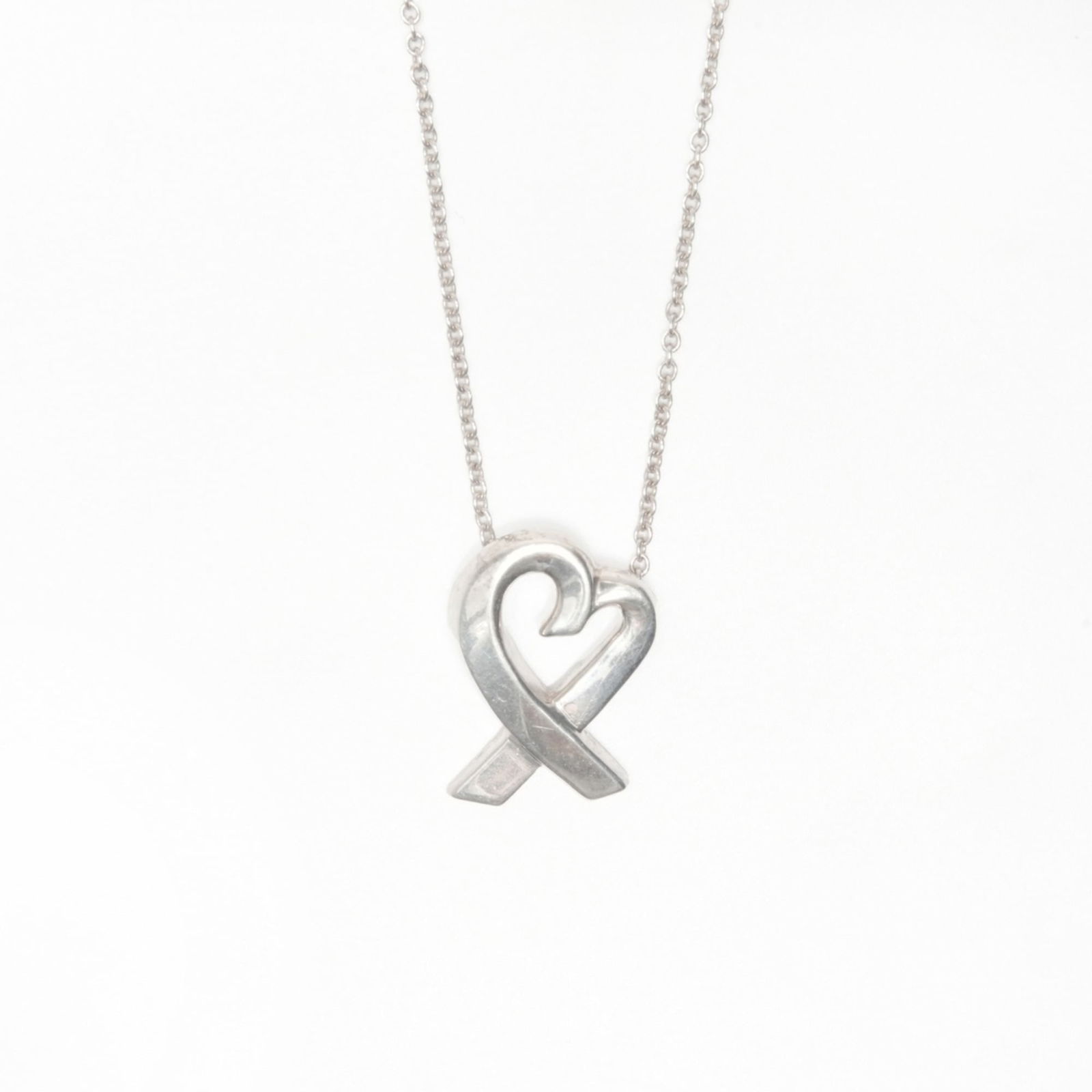 WS24024 - Tiffany & Co. 925 Wrapped Heart Necklace in Silver: WS24024 - Tiffany & Co. 925 Wrapped Heart Necklace in Silver This listing features WS24024 - Tiffany & Co. 925 Wrapped Heart Necklace in Silver. Item specifics are provided below. Item Specifics: