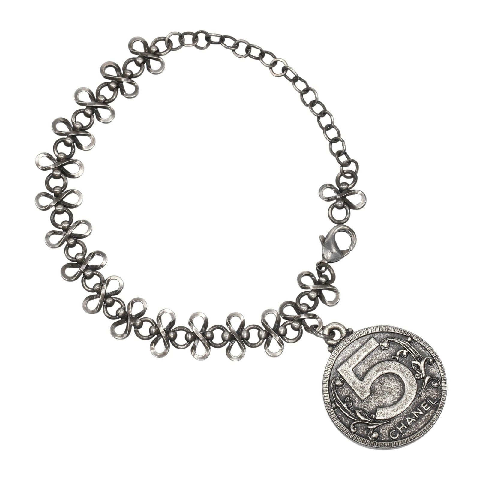Metal Chanel Charm Bracelet: Metal Chanel Charm Bracelet This listing features Metal Chanel Charm Bracelet. Item specifics are provided below. Item Specifics: Brand: Chanel Type: Charm Bracelet Gender: Women Material: Metal