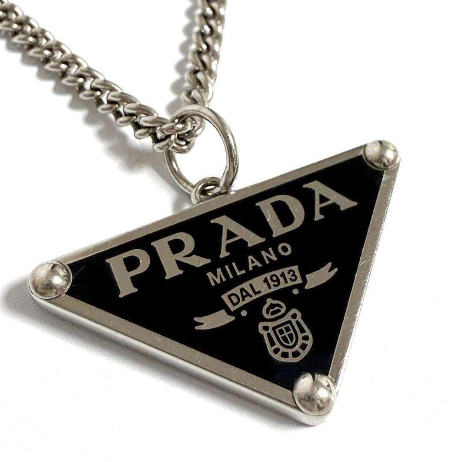 Silver Prada Men's/ Women's Symbol Necklace Pendant in: Silver Prada Men's/ Women's Symbol Necklace Pendant in This listing features Silver Prada Men's/ Women's Symbol Necklace Pendant in. Item specifics are provided below. Item Specifics: Brand: Prada Nec