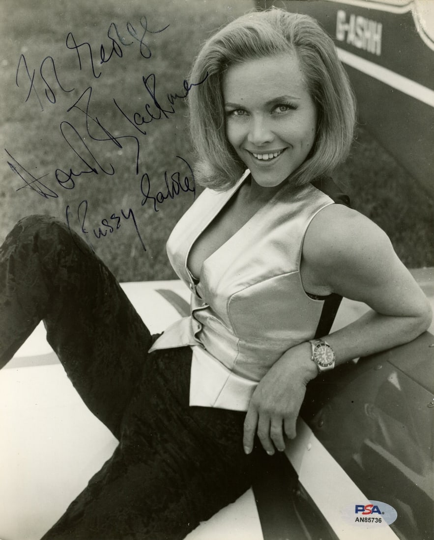 192053 Honor Blackman Signed/ Inscr 8x10 B/ W Photo Actress "Goldfinger" PSA/ DNA: 192053 Honor Blackman Signed/ Inscr 8x10 B/ W Photo Actress "Goldfinger" PSA/ DNA Meet the iconic actress who stole hearts as Pussy Galore in the 1964 James Bond classic, Goldfinger! This rare and aut