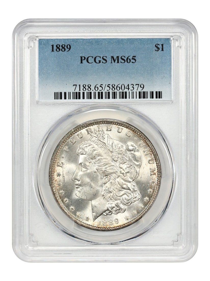 Morgan Dollar - 1889 $1 PCGS MS65: Morgan Dollar - 1889 $1 PCGS MS65 A rare and highly sought-after 1889 Morgan Dollar, certified MS65 by PCGS, is up for auction. This stunning coin boasts pristine condition, with its high grade reflec