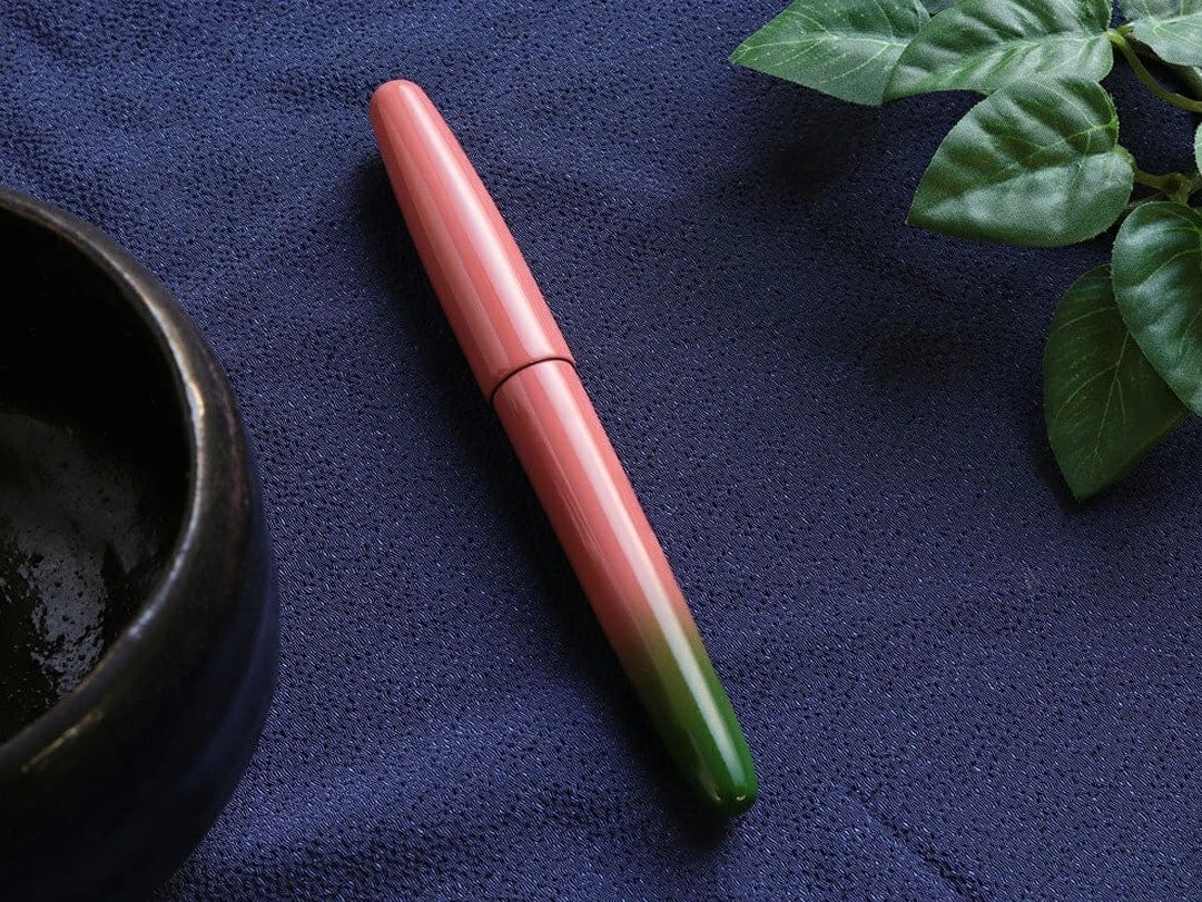 Red Wancher Dream Pen Aizu Urushi Blur Lacquer Fountain Pen M Nib TSUBOMI: Red Wancher Dream Pen Aizu Urushi Blur Lacquer Fountain Pen M Nib TSUBOMI The Red Wancher Dream Pen is a stunning example of Japanese craftsmanship, boasting a beautiful Aizu Urushi lacquer finish