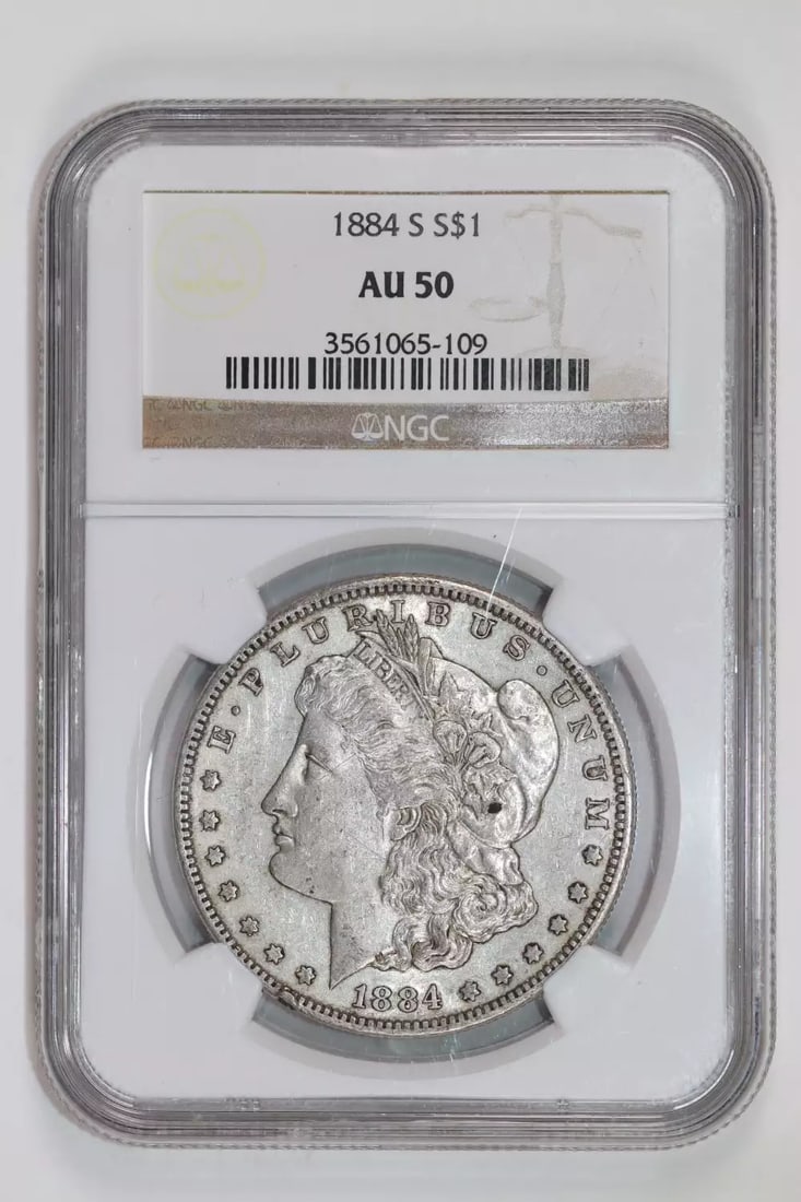 1884-S Morgan Dollar NGC AU50: 1884-S Morgan Dollar NGC AU50 Experience the charm of the 1884-S Morgan Dollar, a rare and highly sought-after coin from the San Francisco Mint. With its AU 50 grade from NGC, this circulated dollar