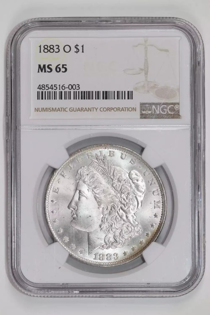 1883-O Morgan Dollar NGC MS65 Rainbow Reverse: 1883-O Morgan Dollar NGC MS65 Rainbow Reverse Experience the beauty of the 1883-O Morgan Dollar, certified by NGC as MS65 Rainbow Reverse. This stunning coin boasts exceptional silver content and is g