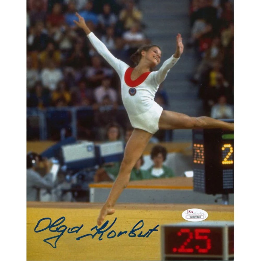 Photo Olga Korbut Autographed 8x10: Photo Olga Korbut Autographed 8x10 Meet the iconic gymnast Olga Korbut, captured in a stunning 8x10 photo signed in blue sharpie by the athlete herself! This rare and authentic autographed image is a