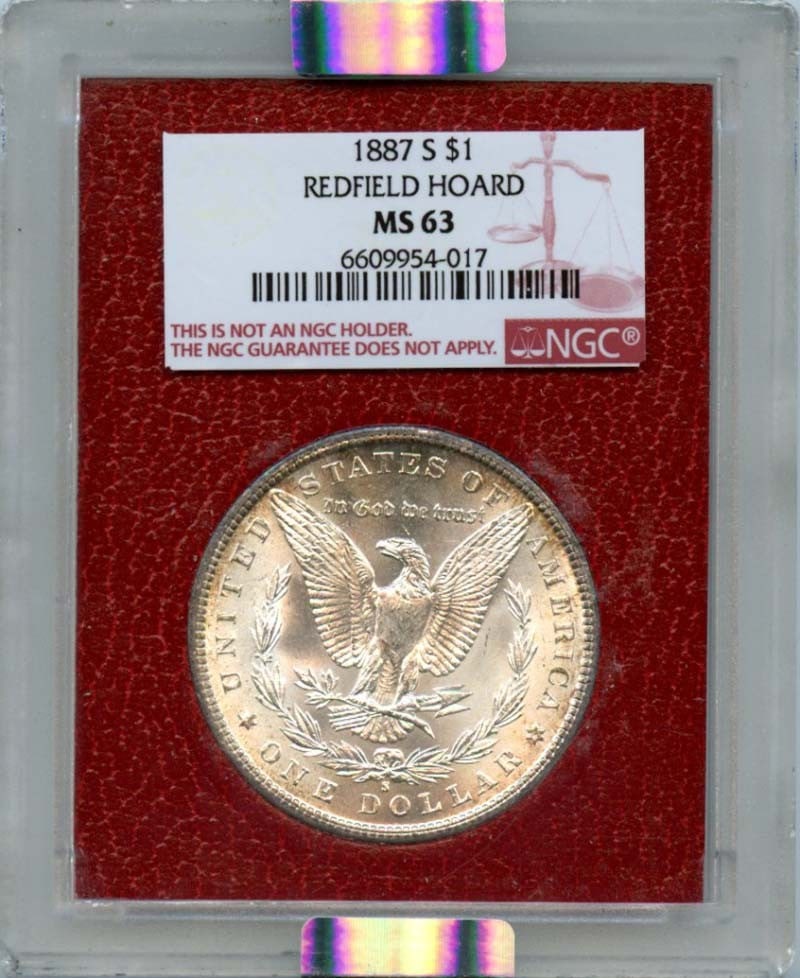 1887-S $1 Morgan Dollar Redfield Hoard - NGC MS63: 1887-S $1 Morgan Dollar Redfield Hoard - NGC MS63 Experience the beauty of the 1887-S $1 Morgan Dollar, certified by NGC as MS63, with its stunning red coloration reminiscent of the Redfield Hoard. Th