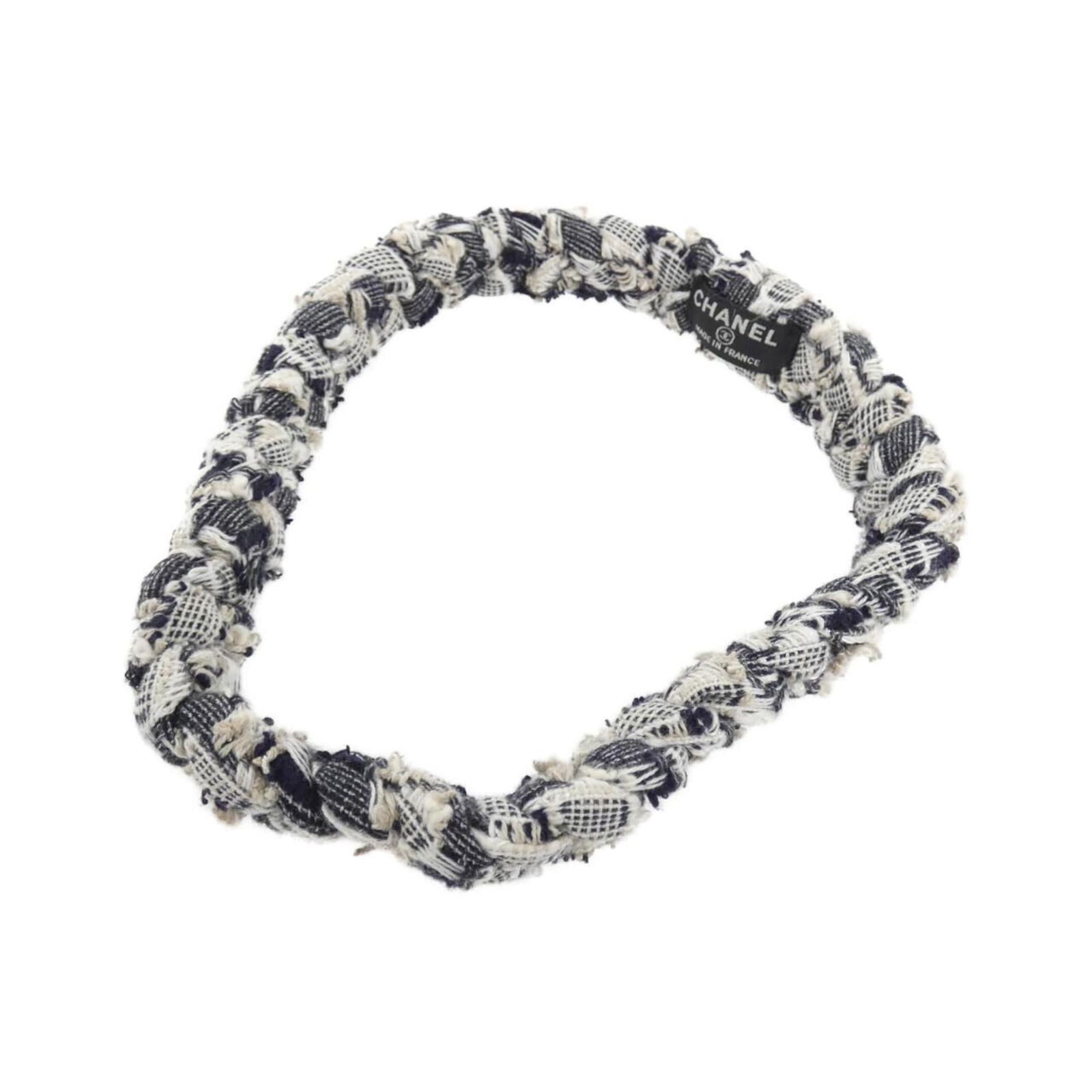 Tie Chanel Hair: Tie Chanel Hair A navy and white Chanel hair tie, adding a touch of timeless elegance to any hairstyle, is up for grabs. With its classic design and high-quality construction, this used hair tie