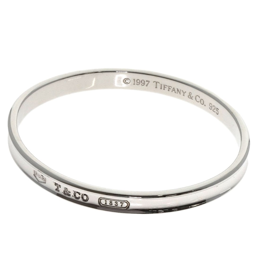 Silver TIFFANY&Co. 1837 bangle Bracelet: Silver TIFFANY&Co. 1837 bangle Bracelet A stunning piece of vintage elegance, this 1837 Tiffany&Co. silver bangle bracelet is a true collector's item. With its sleek, unadorned design and exceptional