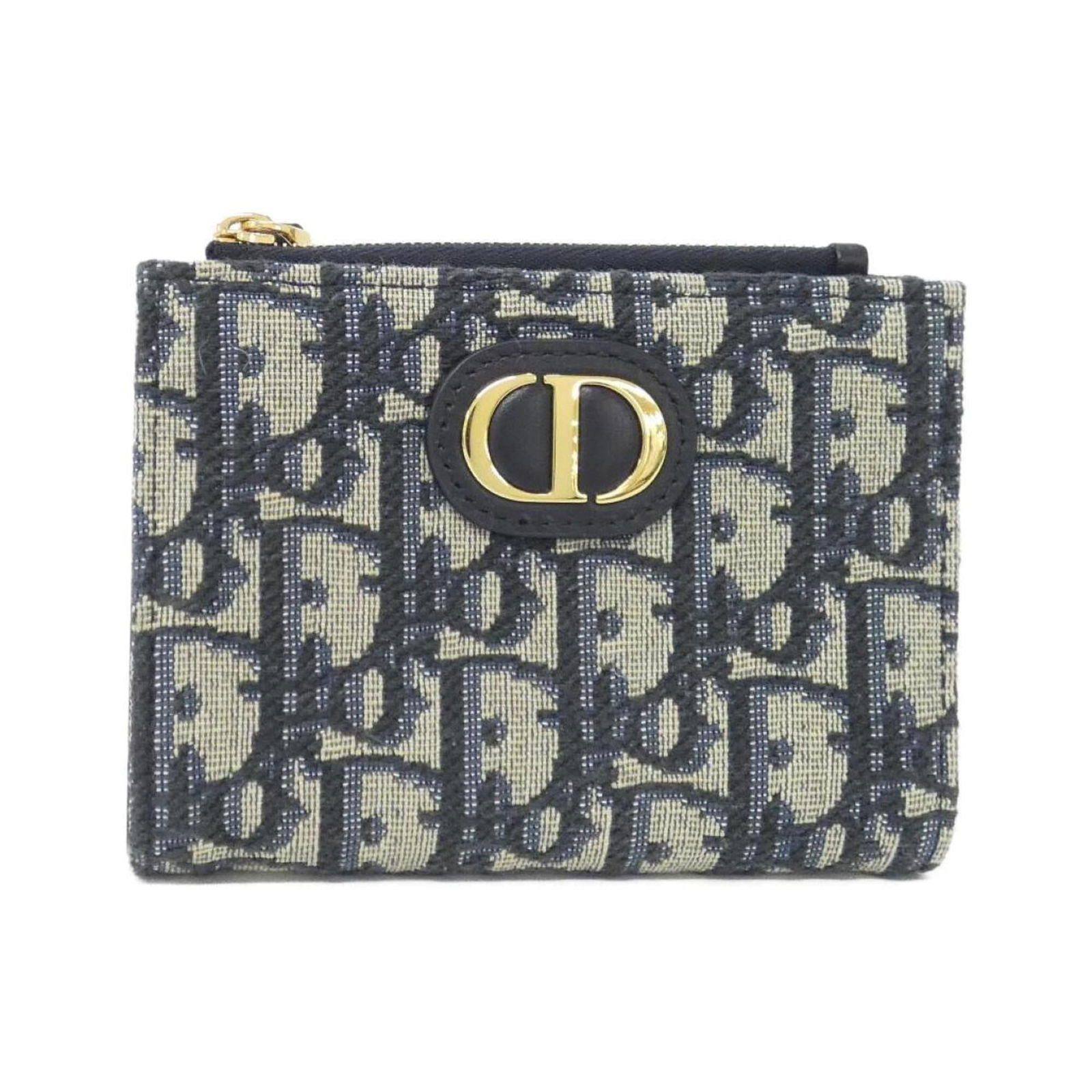 Christian Dior Bi-Fold Canvas Wallet: Christian Dior Bi-Fold Canvas Wallet A stylish and timeless piece from Christian Dior, this bi-fold canvas wallet boasts a classic design with clean lines and a chic blue hue that adds a touch of