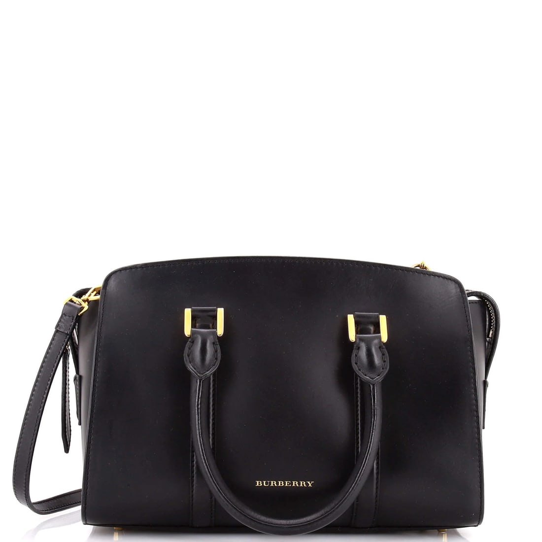 Burberry Welney Satchel in Leather: Burberry Welney Satchel in Leather A classic Burberry Welney Satchel in luxurious leather, this timeless piece boasts a sleek black exterior with gold hardware and a rich brown interior. With its