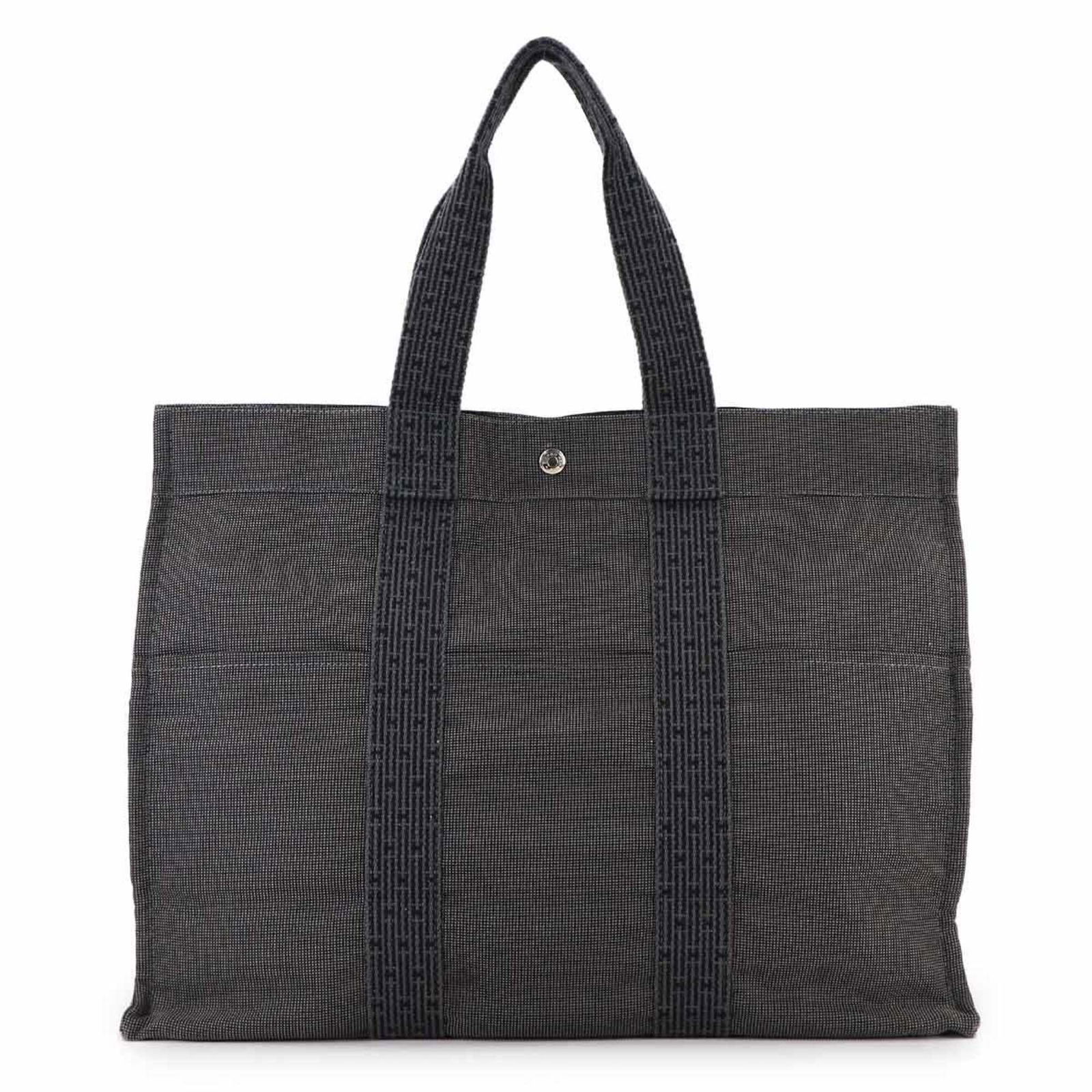 Hermes Canvas Tote Bag: Hermes Canvas Tote Bag Experience the timeless elegance of the iconic Hermes canvas tote bag, crafted from high-quality gray canvas that exudes sophistication and versatility. With its classic design