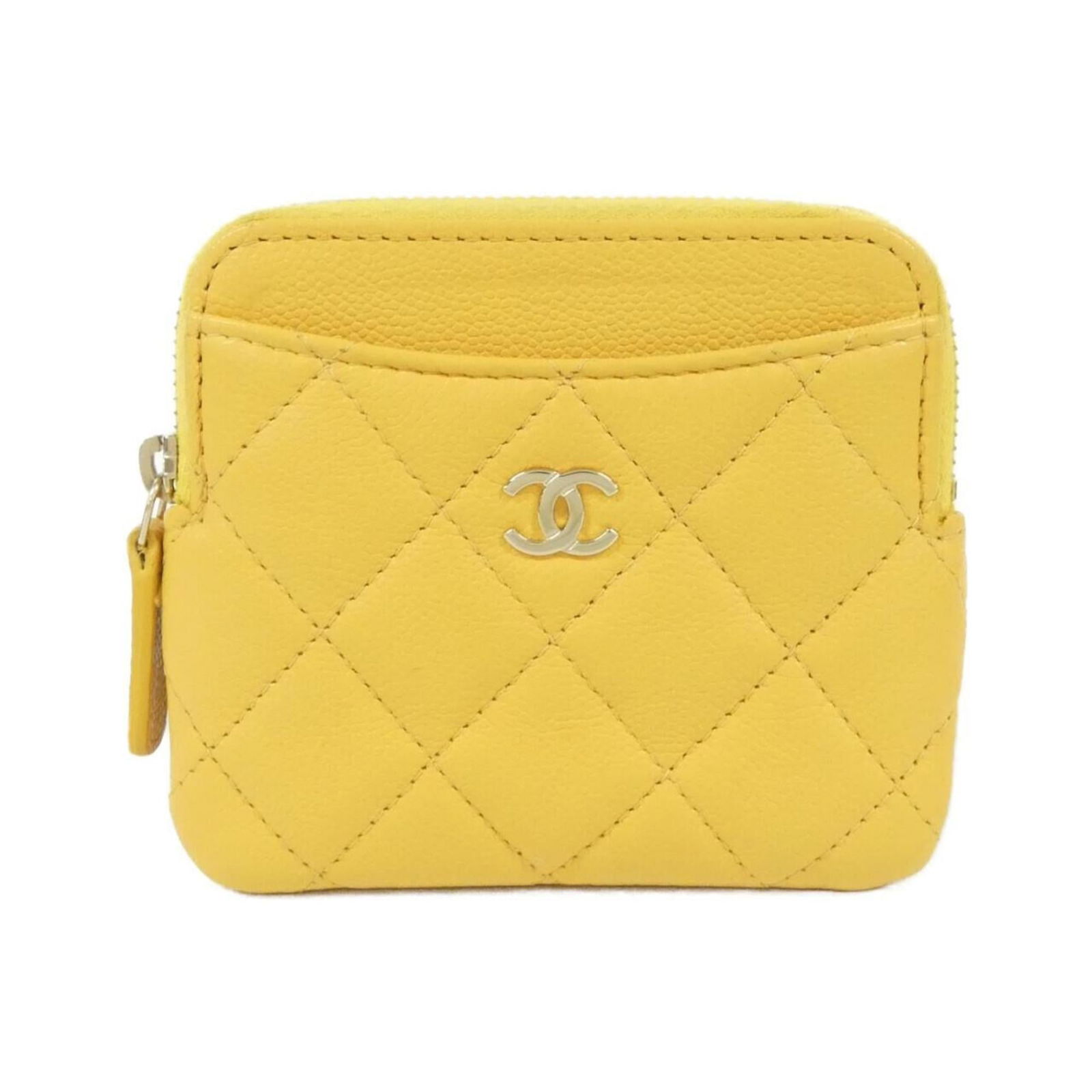 Chanel Coin Purse in Grained Calfskin: Chanel Coin Purse in Grained Calfskin A timeless piece from the iconic Chanel brand, this coin purse is crafted from rich grained calfskin and boasts a sunny yellow hue that adds a touch of warmth to