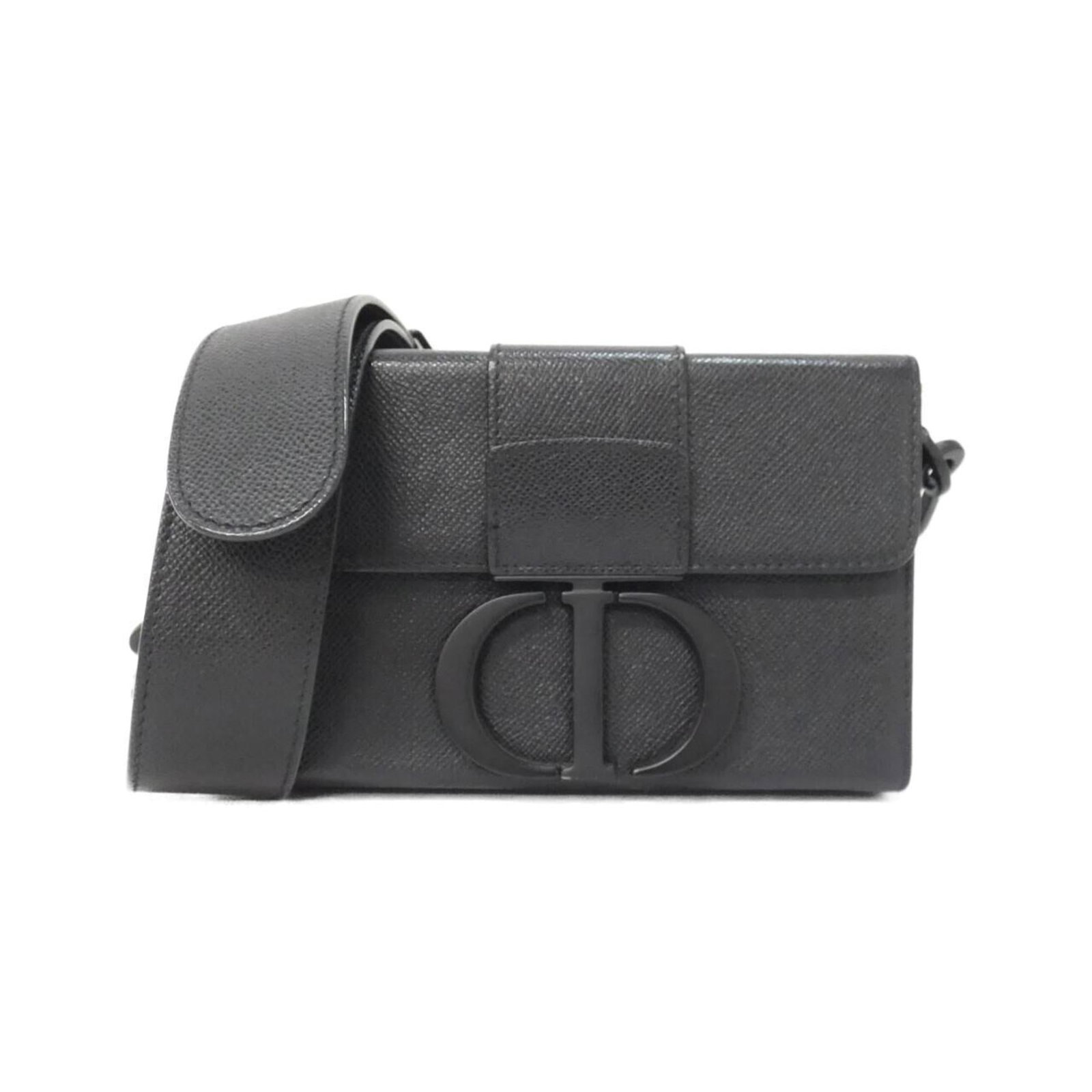 Christian Dior Shoulder Bag in Leather: Christian Dior Shoulder Bag in Leather A sleek and sophisticated shoulder bag from Christian Dior, crafted in rich black calfskin leather that exudes timeless elegance. With its spacious interior and