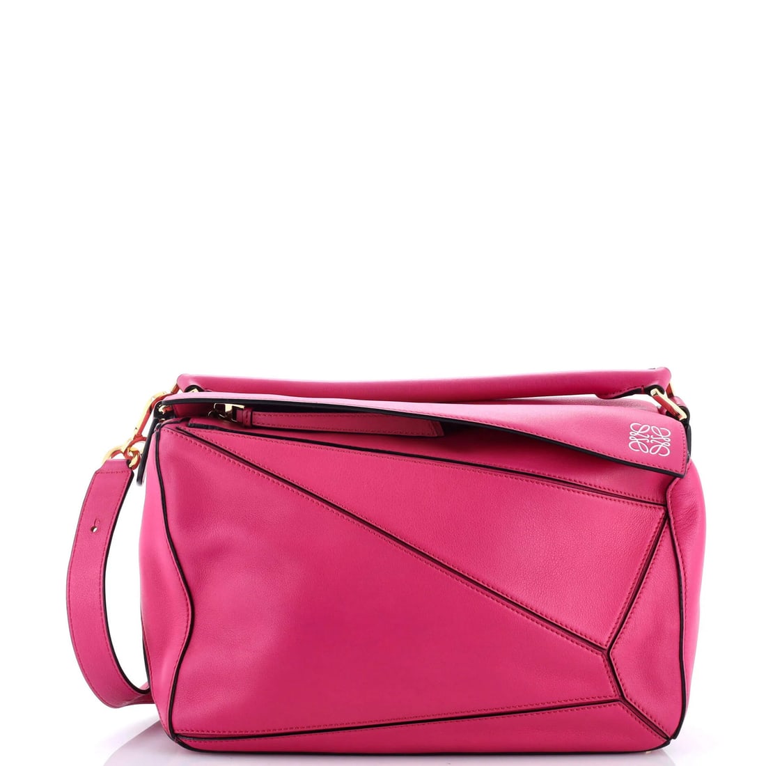 Loewe Puzzle Bag in Medium Leather: Loewe Puzzle Bag in Medium Leather The iconic Loewe Puzzle Bag is a timeless masterpiece, boasting sleek leather exterior in soft pink hues and neutral interior. With its signature puzzle piece
