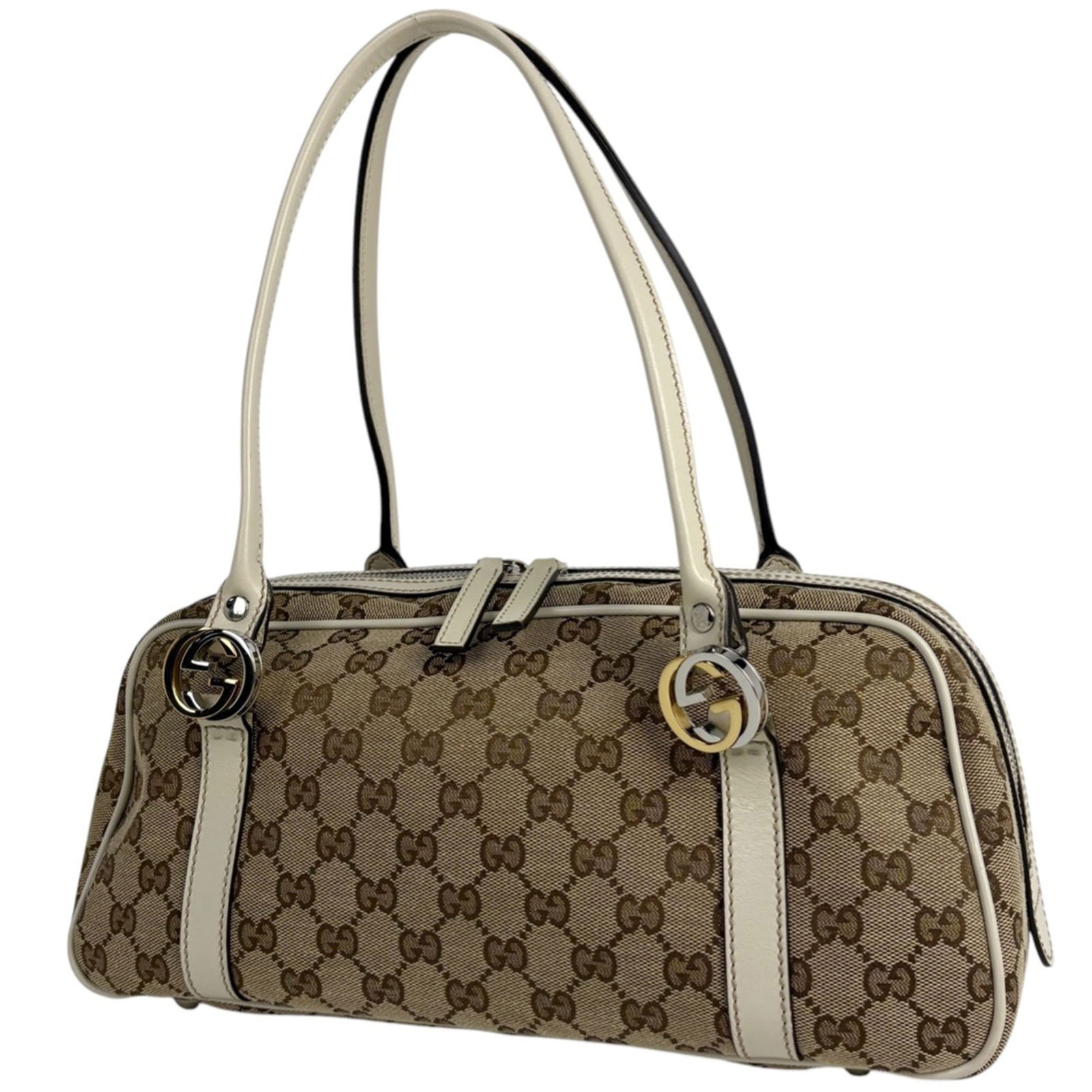 Gucci Canvas and Leather Shoulder Bag: Gucci Canvas and Leather Shoulder Bag A timeless Gucci shoulder bag, crafted from high-quality canvas and leather, boasts a classic beige and white color combination that exudes effortless elegance.