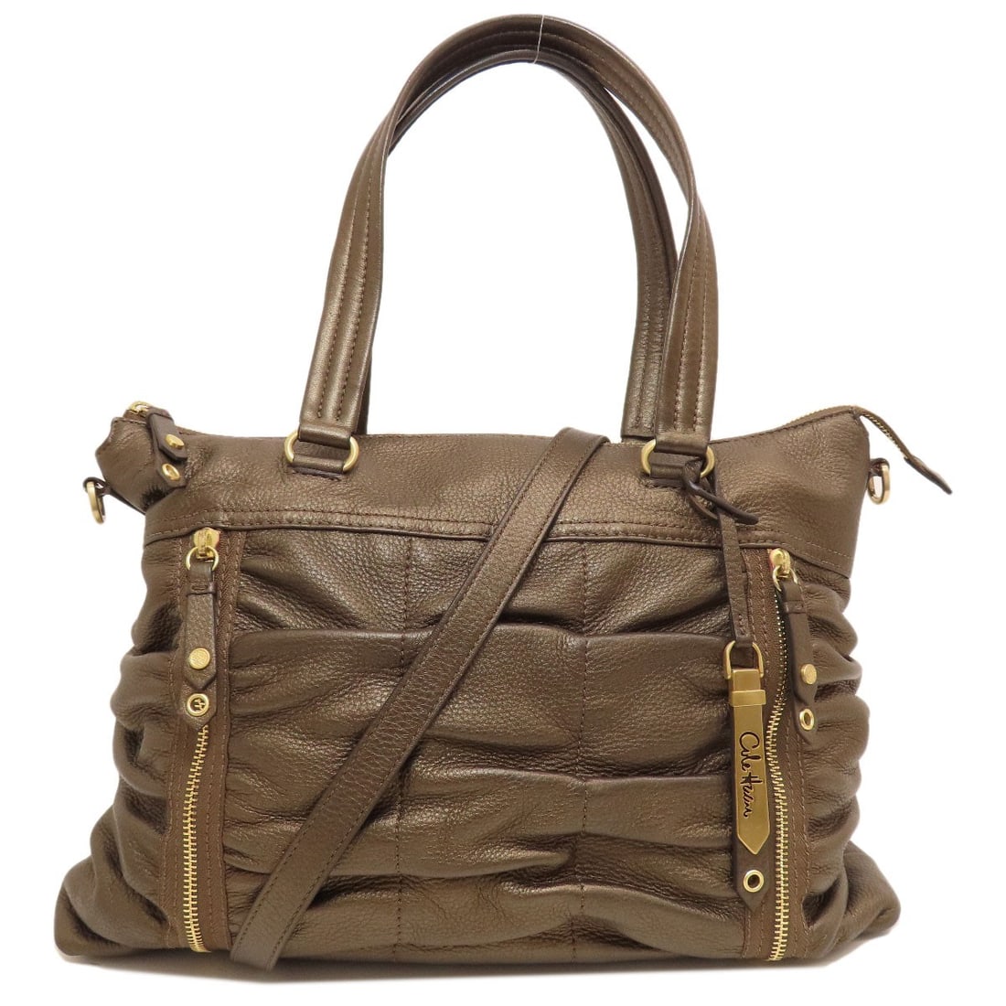 Leather Cole Haan 2WAY Tote Bag: Leather Cole Haan 2WAY Tote Bag Elevate your everyday with the sophisticated Cole Haan 2WAY Tote Bag, crafted from rich bronze leather that adds a touch of luxury to any outfit. Its versatile design