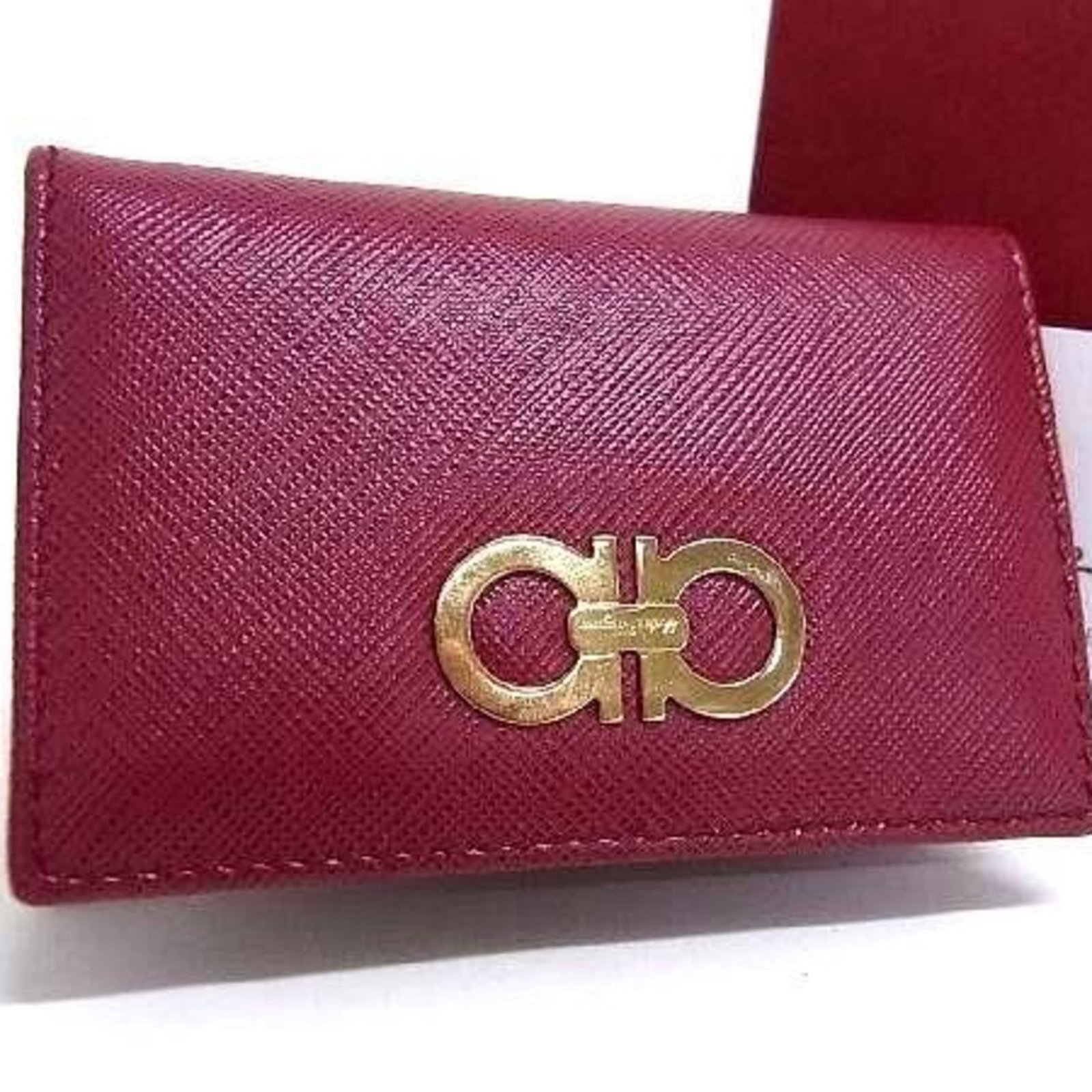 Salvatore Ferragamo Leather Card Case: Salvatore Ferragamo Leather Card Case A sleek and sophisticated accessory for the modern woman, this Salvatore Ferragamo leather card case is crafted from rich, supple wine-colored leather that exudes