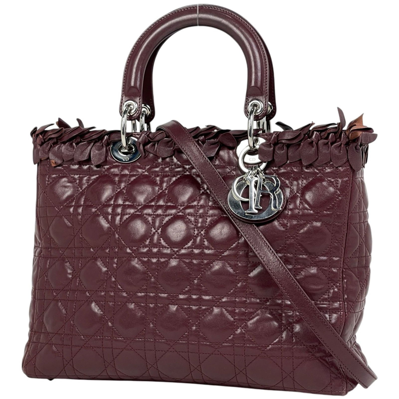 Christian Dior Shoulder Bag in Leather: Christian Dior Shoulder Bag in Leather A timeless piece from the iconic Christian Dior brand, this Bordeaux leather shoulder bag exudes classic sophistication with its sleek design and rich color
