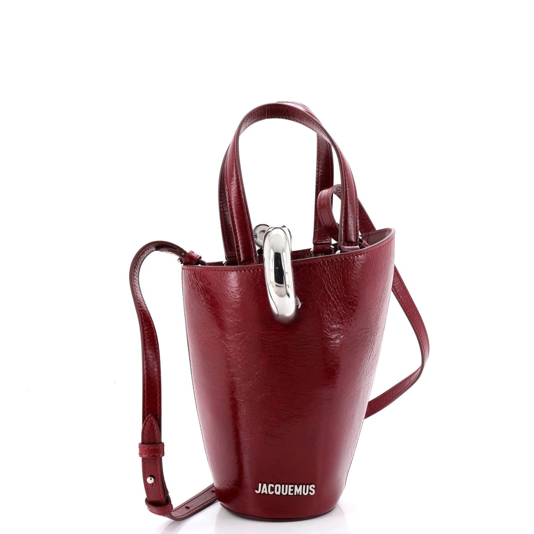 Leather Jacquemus Le Petit Bambola: Leather Jacquemus Le Petit Bambola The Jacquemus Le Petit Bambola is a stylish and iconic top handle bag, crafted from rich red leather that exudes sophistication and elegance. With its classic design