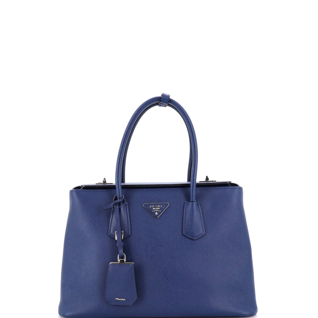 Prada Turnlock Cuir Twin Tote in Saffiano Leather (Small): Prada Turnlock Cuir Twin Tote in Saffiano Leather (Small) The Prada Turnlock Cuir Twin Tote in Saffiano Leather is a timeless, high-end accessory that exudes sophistication and elegance. With its
