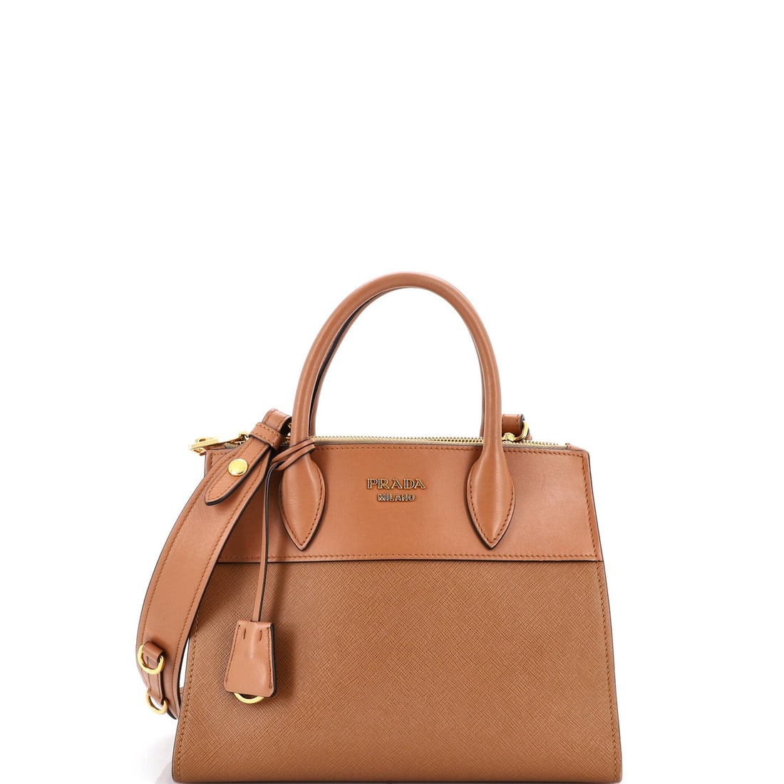 Prada Paradigme Saffiano Tote in Small City Calf: Prada Paradigme Saffiano Tote in Small City Calf Experience the timeless elegance of Prada's Paradigme Saffiano Tote, crafted from rich brown City Calf leather that develops a beautiful patina with