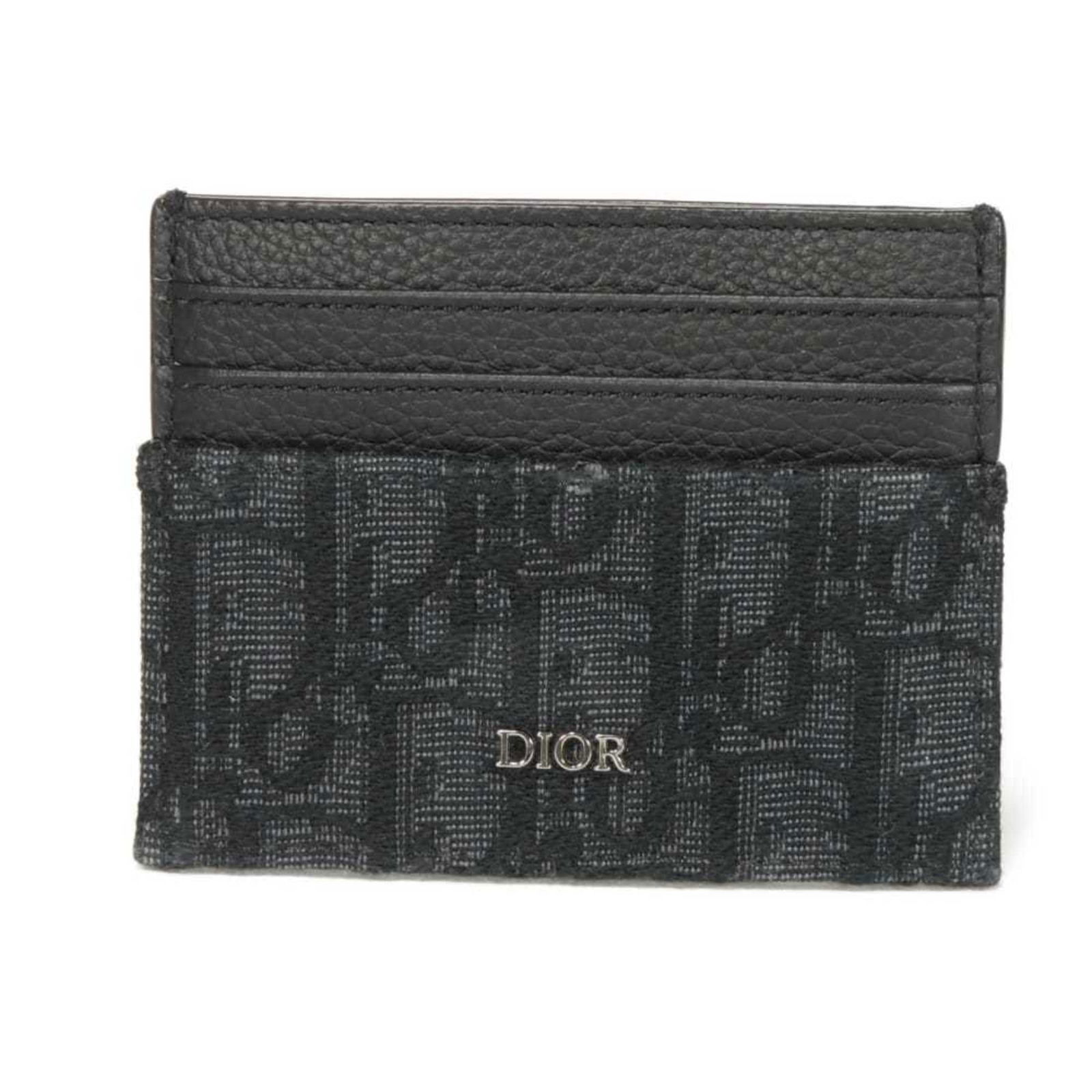Christian Dior Jacquard Card Case: Christian Dior Jacquard Card Case A sleek and sophisticated accessory for the modern man, this Christian Dior Jacquard Card Case boasts a luxurious black finish and open closure, perfect for easily
