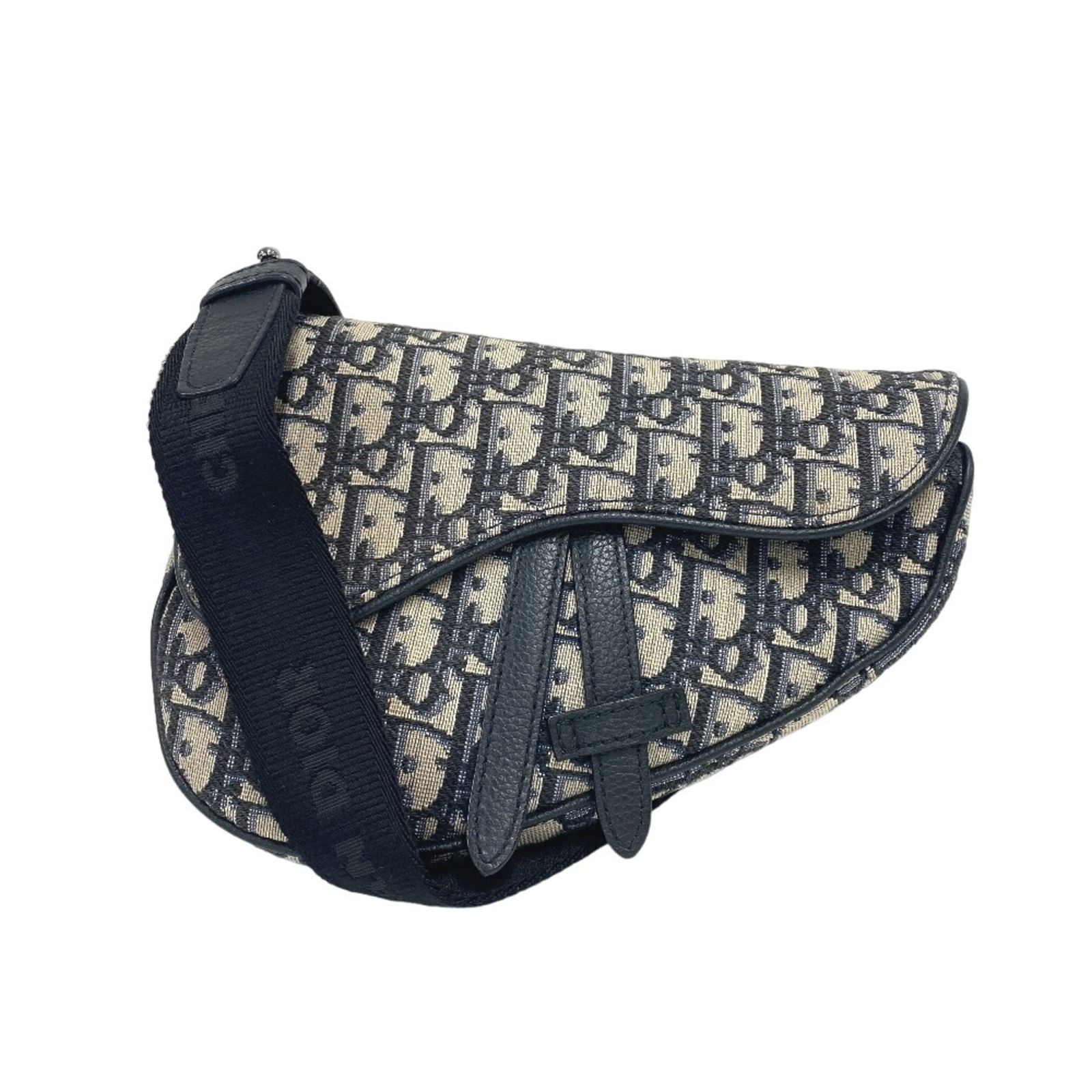 Christian Dior Saddle Sling Bag in Canvas: Christian Dior Saddle Sling Bag in Canvas A timeless piece from Christian Dior, the Saddle Sling Bag in Canvas exudes effortless chic with its classic saddle shape and sleek navy hue. With its