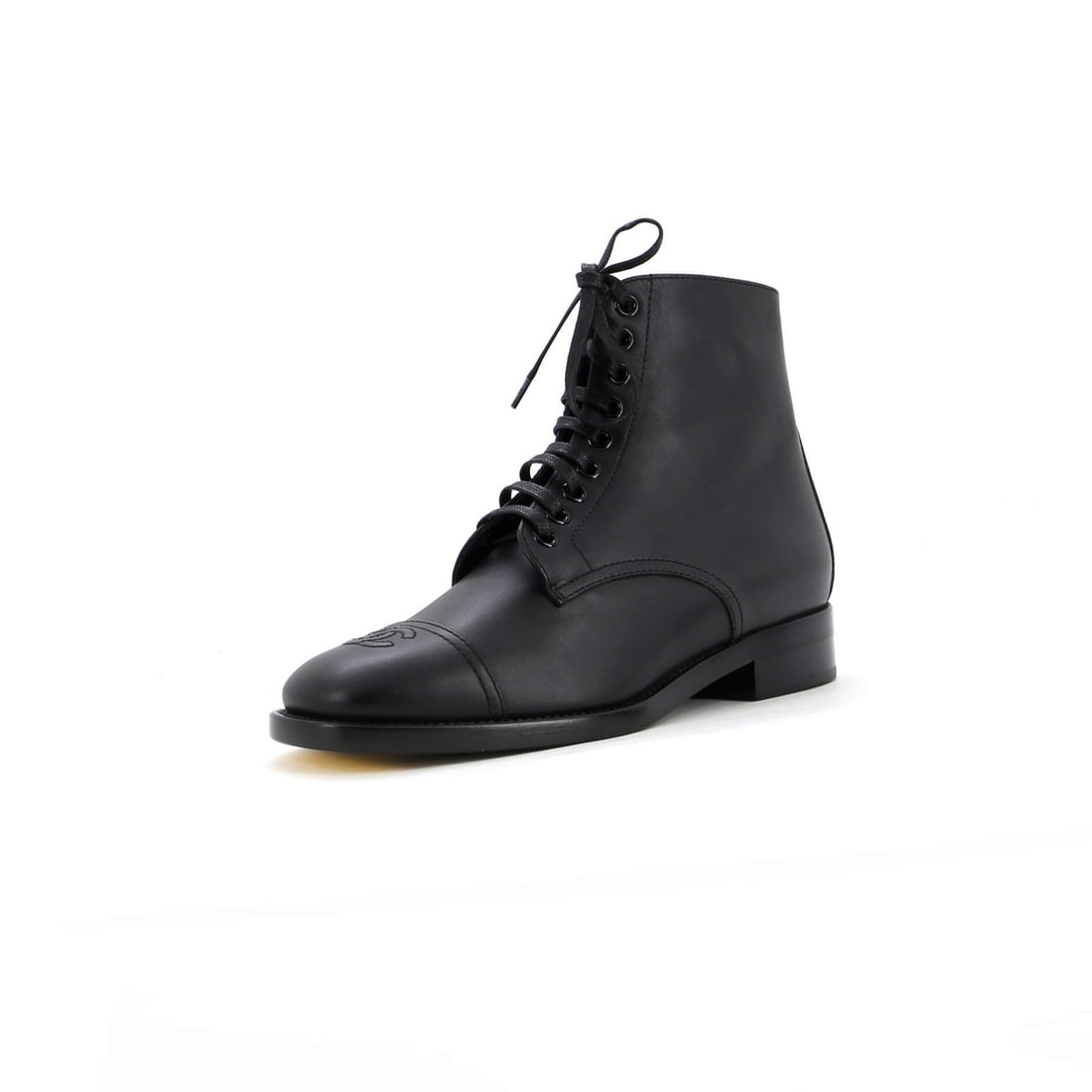 Chanel Women's Cap-Toe Combat Boots in Leather: Chanel Women's Cap-Toe Combat Boots in Leather Elevate your shoe game with the iconic Chanel Cap-Toe Combat Boots, crafted from rich black leather that exudes sophistication and edge. With its sleek c