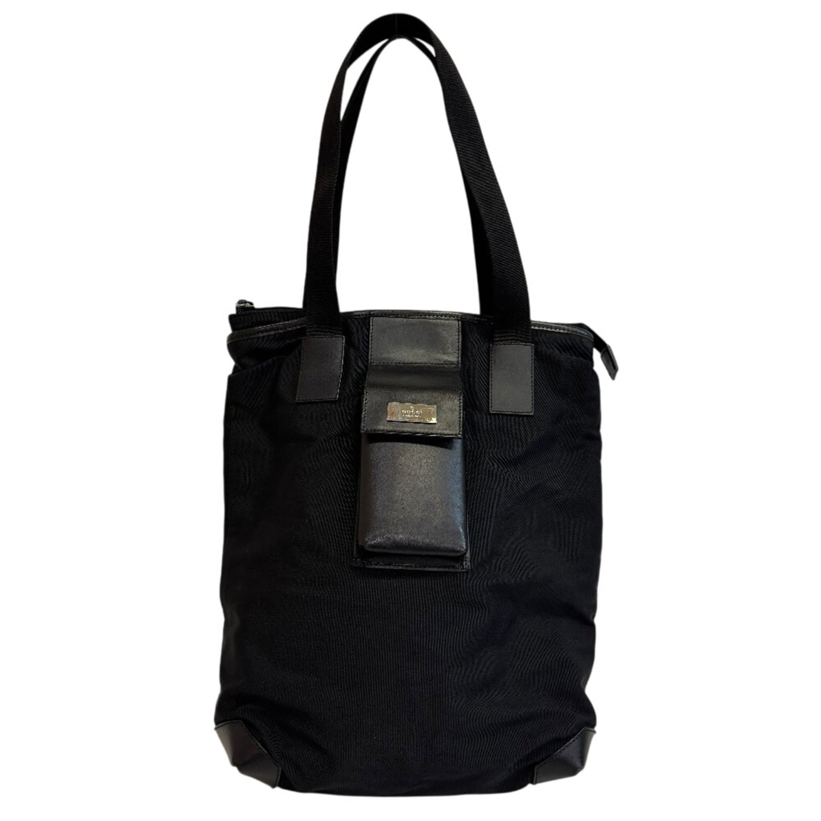 Gucci Tote Bag in Nylon: Gucci Tote Bag in Nylon A sleek and timeless Gucci tote bag in black nylon, perfect for everyday use. With its classic design and durable material, this bag is sure to add a touch of sophistication