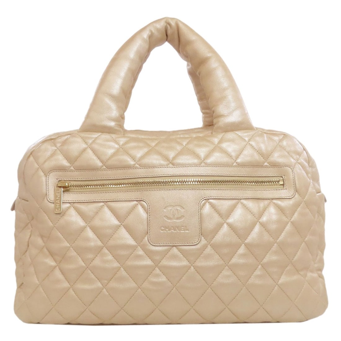 Lambskin CHANEL Cococoon GoldHardware Boston bag: Lambskin CHANEL Cococoon GoldHardware Boston bag Elevate your style with the iconic CHANEL Boston bag, crafted from luxurious lambskin and adorned with gleaming gold hardware. This timeless piece exud