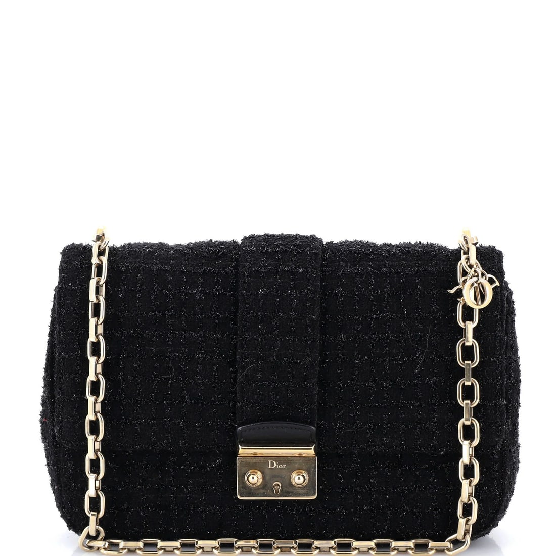Christian Dior Miss Dior Flap Bag in Tweed Medium: Christian Dior Miss Dior Flap Bag in Tweed Medium The iconic Miss Dior Flap Bag in Tweed Medium is a timeless classic, boasting a sophisticated tweed exterior and sleek leather interior. With its sign