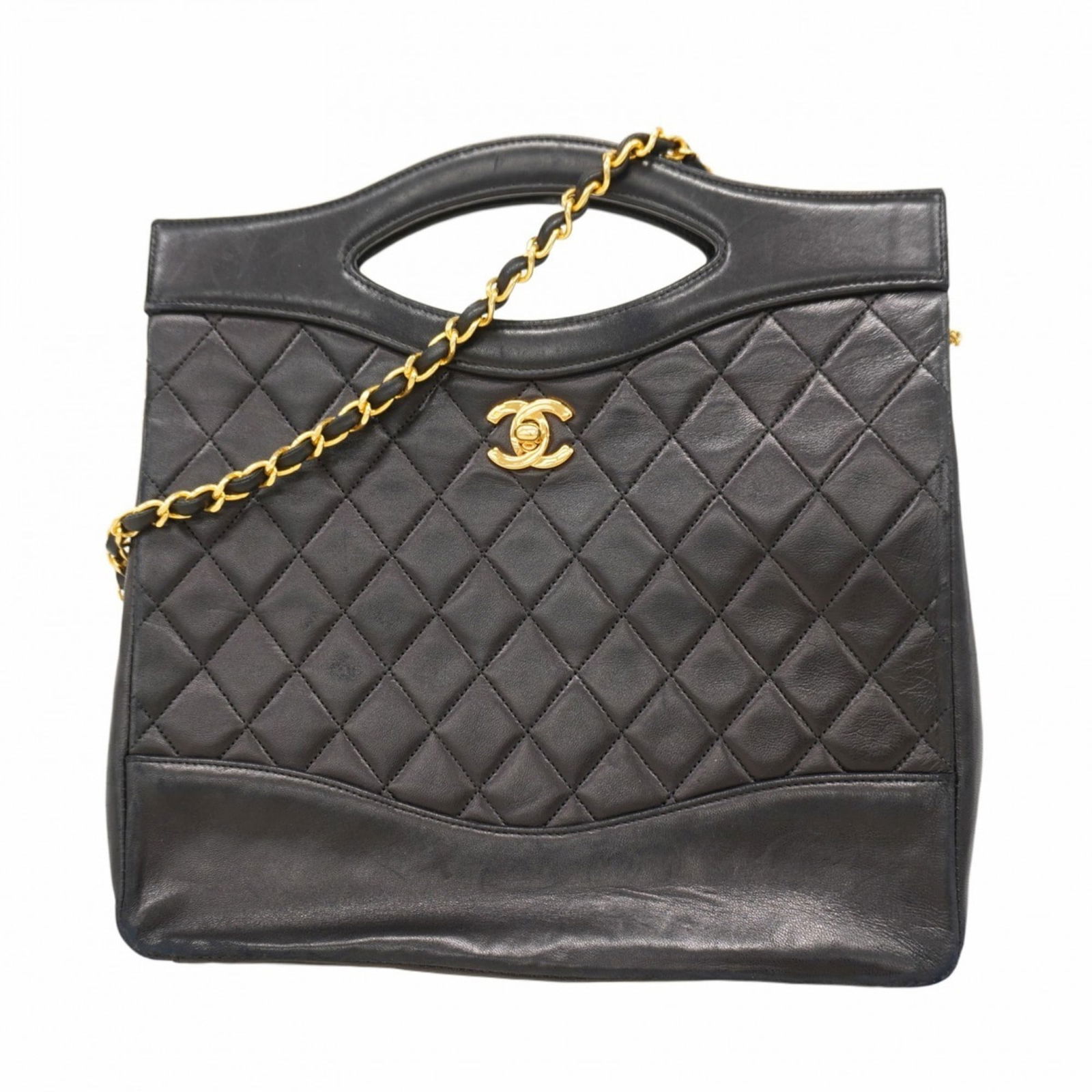 Chanel Leather Handbag: Chanel Leather Handbag A timeless Chanel lambskin handbag in sleek black, adorned with gold hardware, adds an air of sophistication to any outfit. With its classic design and luxurious leather finish,