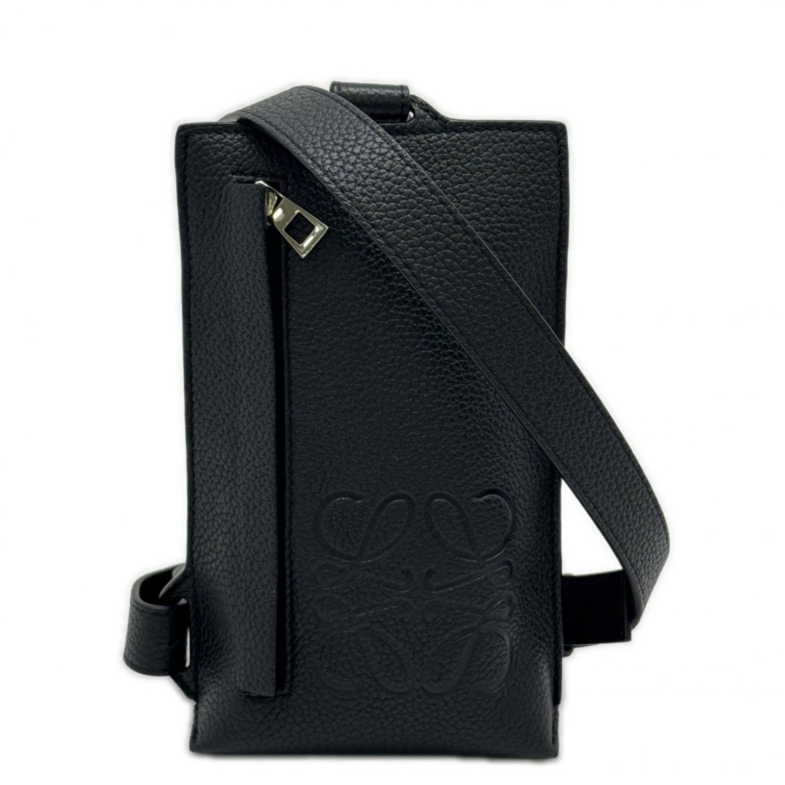 Loewe Sling Bag in Leather: Loewe Sling Bag in Leather A sleek and sophisticated Loewe sling bag in black leather, perfect for adding a touch of luxury to any outfit. With its sturdy zipper closure, adjustable strap length, and