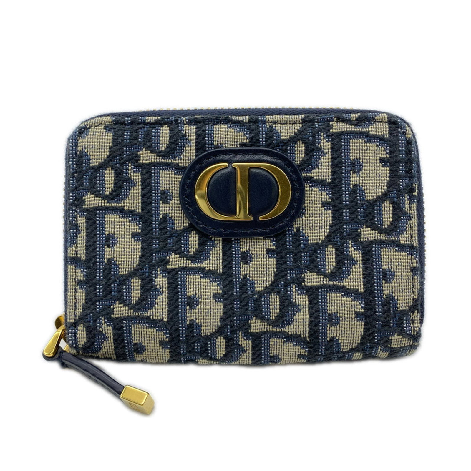 Christian Dior Coin Purse in Cotton and Leather: Christian Dior Coin Purse in Cotton and Leather A chic and timeless piece from the iconic Christian Dior brand, this coin purse is crafted from luxurious lambskin leather and adorned with cotton