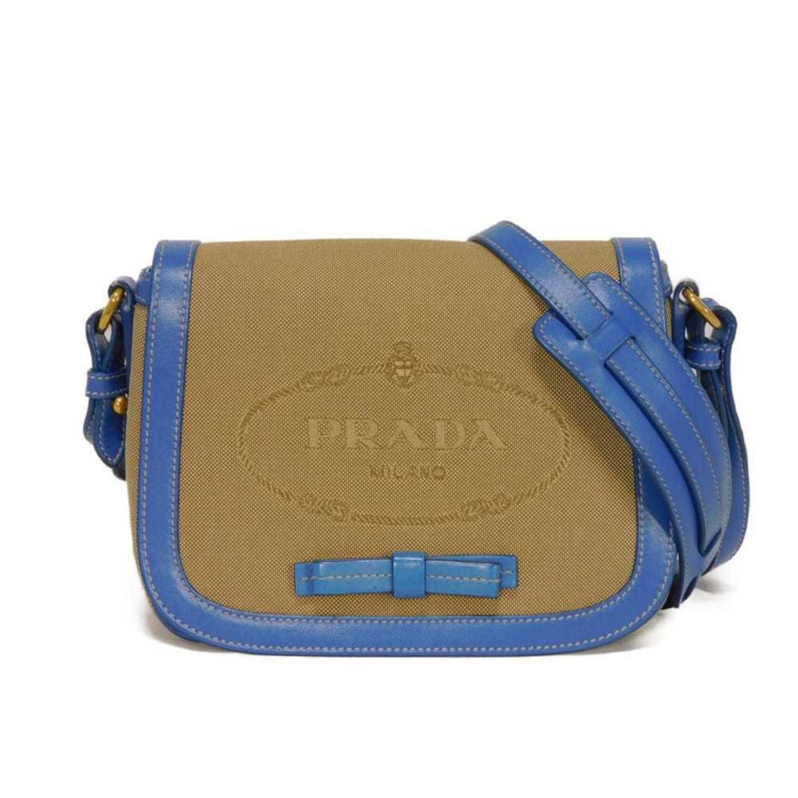 Prada Canvas and Leather Shoulder Bag: Prada Canvas and Leather Shoulder Bag A timeless Prada shoulder bag, crafted from supple leather and canvas, boasts a classic design that exudes understated elegance. With its spacious interior and st