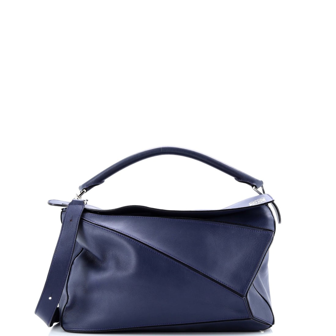 Loewe Large Leather Puzzle Bag: Loewe Large Leather Puzzle Bag The iconic Loewe Puzzle Bag is a timeless classic, boasting a spacious interior and sturdy leather exterior in rich blue hue. With its signature puzzle piece design and