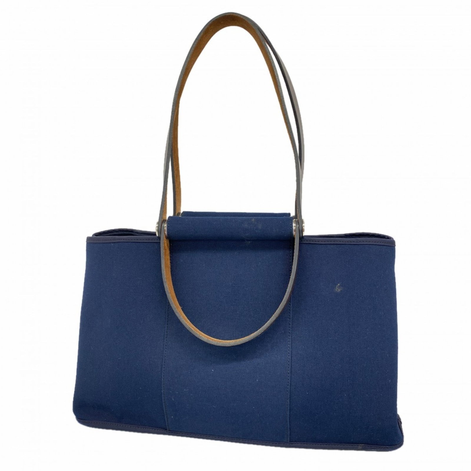 Hermes Canvas Tote Bag: Hermes Canvas Tote Bag A pre-owned Hermes canvas tote bag in navy, boasting the iconic brand's signature style and quality. With its classic design and sturdy silver hardware, this versatile bag is