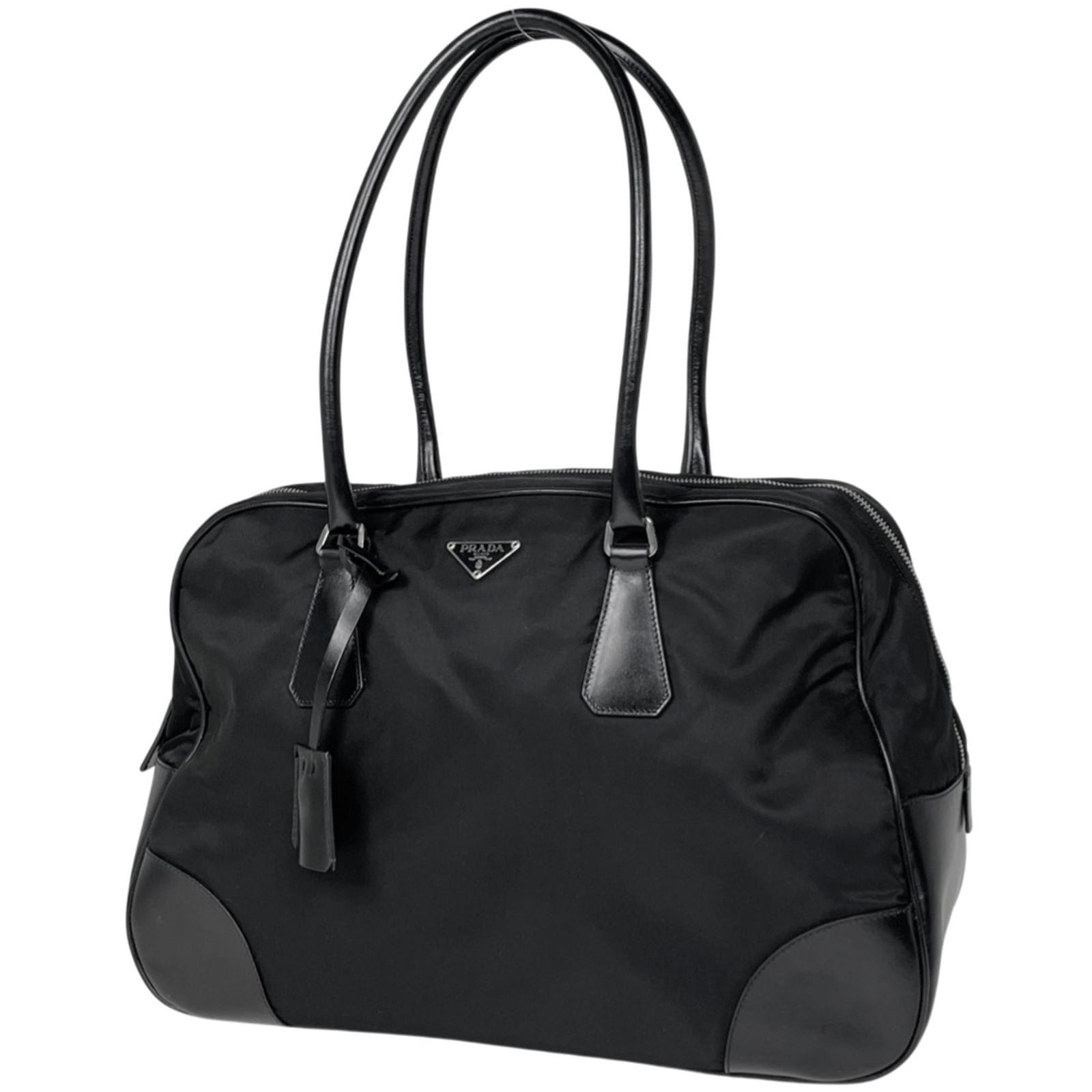 Prada Boston Nylon Handbag: Prada Boston Nylon Handbag A sleek and versatile Prada Boston Nylon Handbag, perfect for everyday use, boasts a durable nylon exterior with a timeless black finish. With its spacious interior and