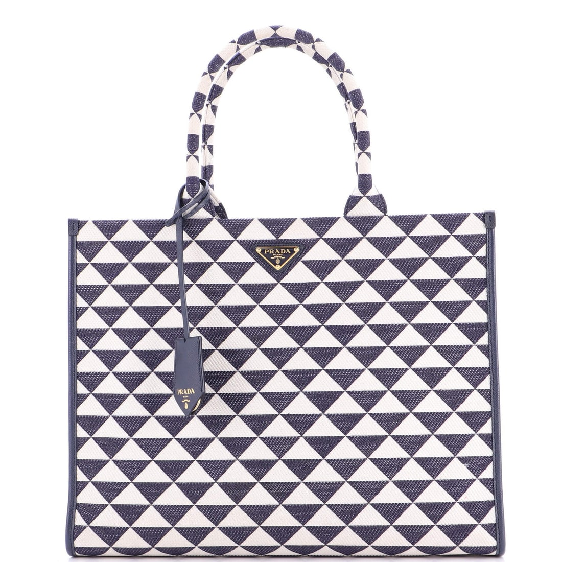 Prada Symbole Shopper Tote in Large Jacquard: Prada Symbole Shopper Tote in Large Jacquard The Prada Symbole Shopper Tote in Large Jacquard is a timeless and sophisticated accessory that exudes luxury. With its striking blue exterior adorned with