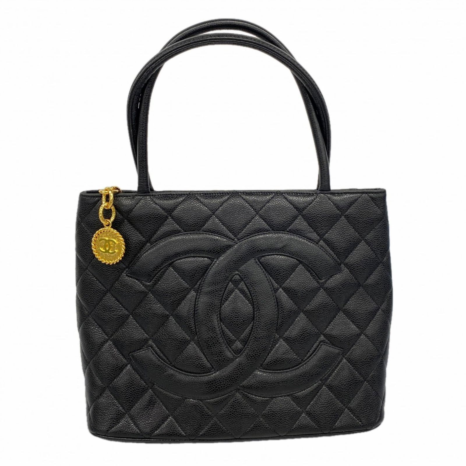 Chanel Calfskin Tote Bag: Chanel Calfskin Tote Bag A sleek and sophisticated Chanel calfskin tote bag in classic black, adorned with elegant gold hardware, is now available. With its timeless design and high-quality materials,