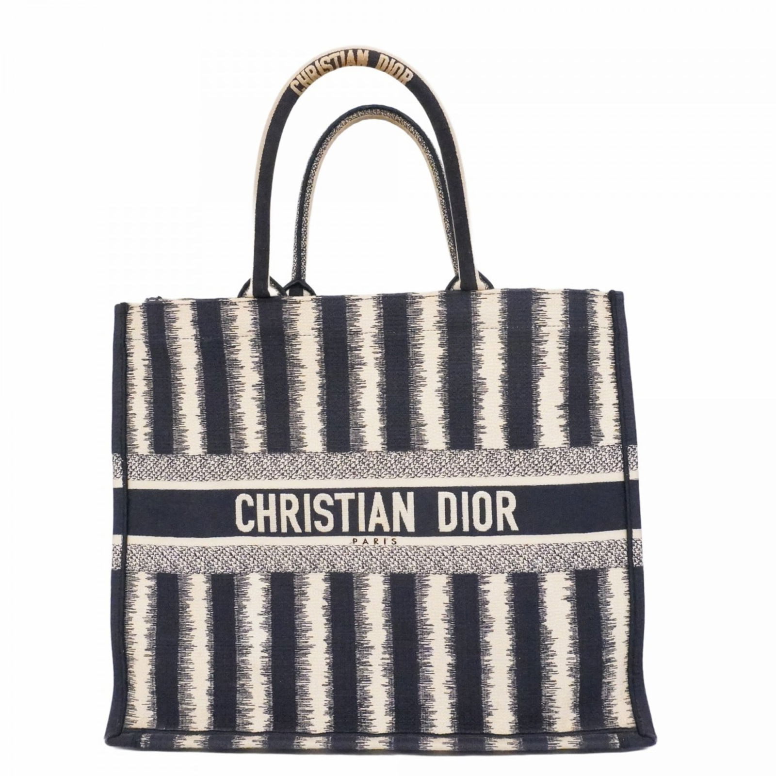Christian Dior Canvas Tote Bag: Christian Dior Canvas Tote Bag A timeless and elegant addition to any woman's wardrobe, this classic Christian Dior canvas tote bag boasts a chic beige and navy color combination that exudes