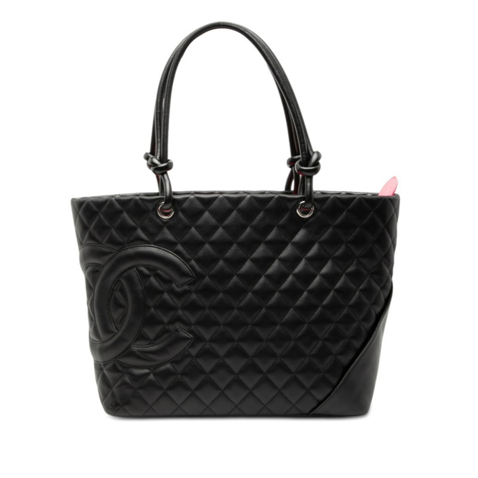 Leather Chanel Tote Bag: Leather Chanel Tote Bag A timeless and sophisticated black leather tote bag from the iconic Chanel brand, crafted from luxurious lambskin that exudes elegance and refinement. With its classic design