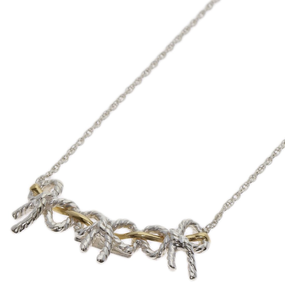 Tiffany & Co. 18k Yellow Gold Triple Ribbon Necklace in Silver: Tiffany & Co. 18k Yellow Gold Triple Ribbon Necklace in Silver Elevate your elegance with the Tiffany & Co. 18k Yellow Gold Triple Ribbon Necklace in Silver, a timeless piece that exudes