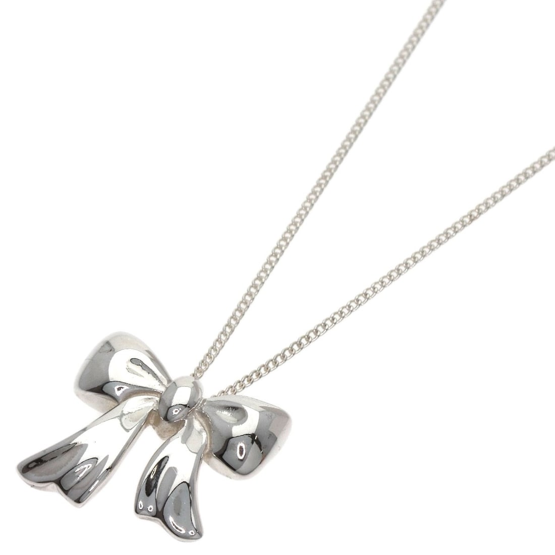 Tiffany & Co. Silver Ribbon Necklace: Tiffany & Co. Silver Ribbon Necklace Elevate your elegance with the timeless Tiffany & Co. Silver Ribbon Necklace, crafted from sterling silver and boasting an understated sophistication that's