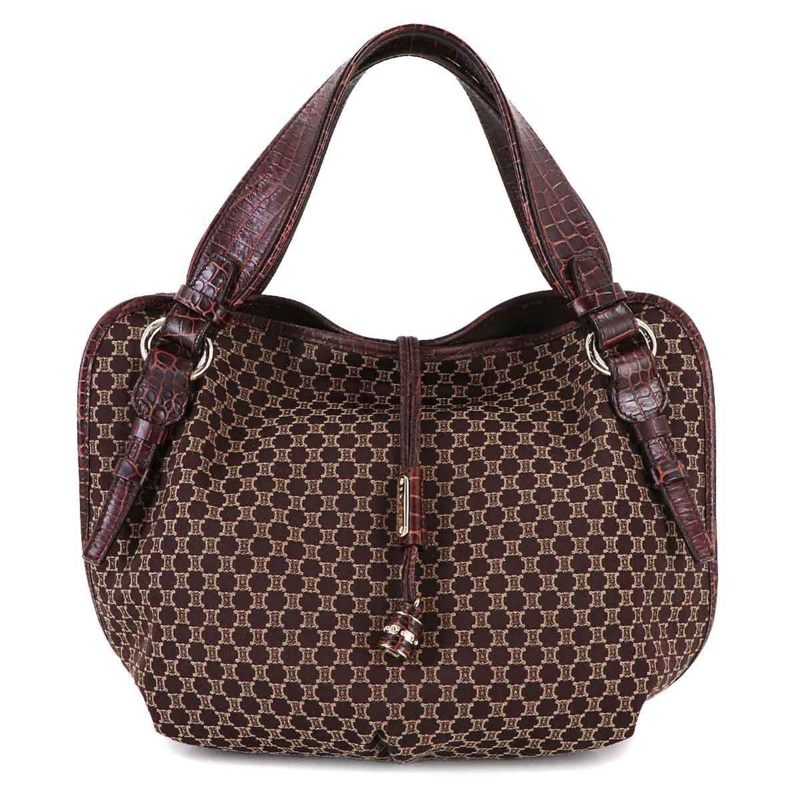 Celine Canvas and Leather Handbag: Celine Canvas and Leather Handbag A timeless and sophisticated dark brown Celine handbag, crafted from high-quality canvas and supple leather, boasts a sleek 26cm design that exudes understated