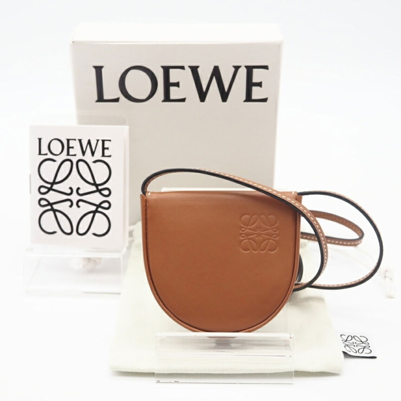 Loewe Leather Shoulder Bag: Loewe Leather Shoulder Bag "Elegant and understated, the Loewe Leather Shoulder Bag exudes sophistication with its rich brown calfskin leather and sleek flap closure. With a slender 94cm strap