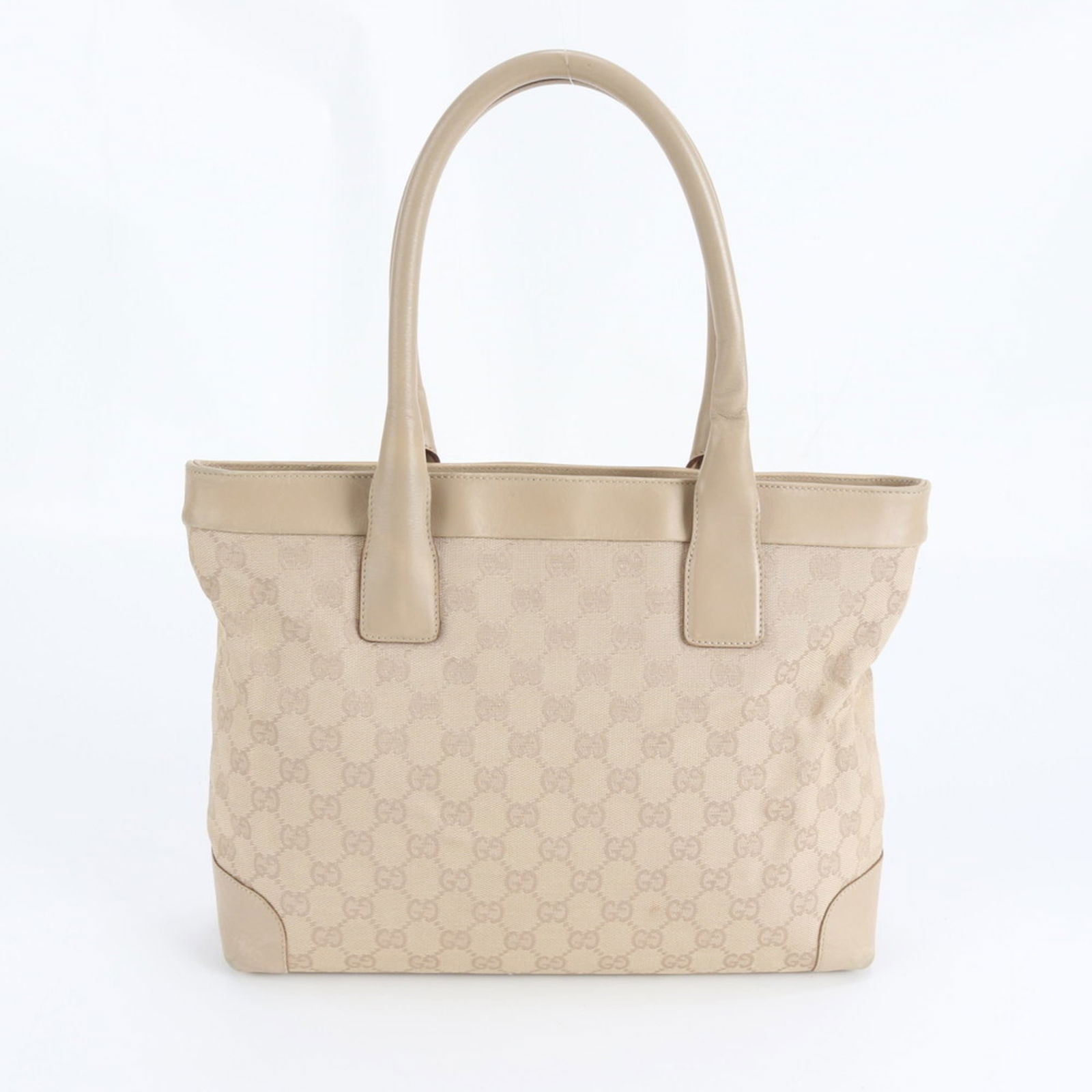 Gucci Tote Bag in Leather and Canvas: Gucci Tote Bag in Leather and Canvas A pre-owned Gucci tote bag in rich beige, combining supple leather and canvas for a unique texture. With its classic design and spacious interior, this stylish